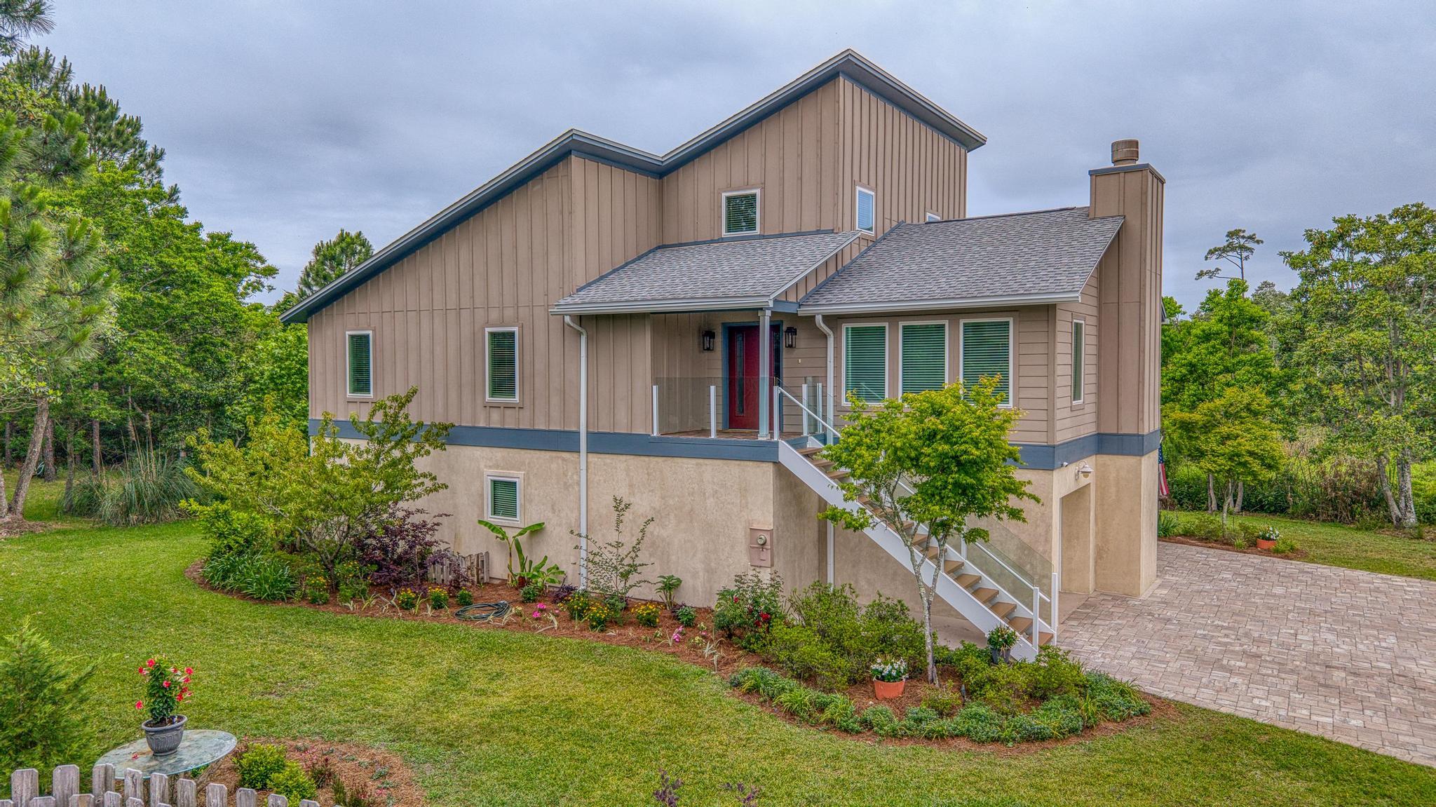 Own the Florida water lifestyle for a fraction of the price.  Welcome to Gulf Breeze Florida.  Minutes from Emerald waters and white sand of Pensacola Beach.  Waterviews of the Santa Rosa Sound, plus surrounded by greenspace, this unique setting offers you luxury and privacy. Completely remodeled in 2018, take in the hardie siding and custom antigue washed hard coat stucco.  Walk up the cypress plank stairs to the covered fornt porch.  Open the door, let your eyes sweep over the luxury vinyl plank flooring, the custom white washed ceilings in the great room and sunroom, the crown molding and wide basebaords.  The light and bright kitchen with it's hand made, on site, centerpiece island and quartz countertop is a show stopper.  The walk in custom made pantry door's white wash finish compliments the ceilings.  The gas stovetop, stainless steel appliances.  The details. The tinted windows in the sunroom which has it's own air conditioner, the elegant ceiling fans.  Step outside onto the canvas covered deck.  Check out the Eagles, a nesting pair come back year after year.  The greenspace to the North and West is preserved, your sunset views are endless. Back inside you'll find 3 bedrooms and 3 full baths on the first floor. Two of the baths boast antique vanities.  One bedroom comes with a huge walk in closet and a private deck.  But there's more. Head upstairs to the luxury bedroom.  A soaring ceiling, views of the Sound, 2 walk in closets, a primary bathroom with designer tile in the walk in double shower, 2 more made on site doors, teak wood which compliments an art wall in the bath.  A mini split HVAC for total comport. A coffee bar with mini fridge with custom cabinentry completes the interior.  Step out onto the private canvas covered deck for more sunsets.  2025/26 updates include drywalling and painting the downstairs bonus room.  Nearly 800 square feet for you to imagine.  A playroom, game room, family room, man cave.  The possibilities are endless. The over sized garage fits cars and more toys.