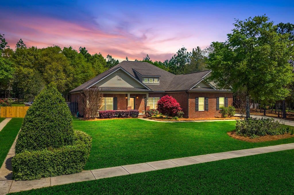 Are you searching for privacy, peace, and true country living? Look no further, this is the home you've been waiting for. Tucked away at the end of the subdivision, this stunning Randy Wise-built home offers the perfect blend of seclusion and style. From the moment you arrive, you're welcomed by a custom extra wide driveway and sidewalk that extends beyond the fence for a RV or boat, leading to a spacious side-entry garage. This Craftsman-style home showcases timeless design paired with modern comfort. The heart of the home features an open-concept living, dining, and kitchen area--ideal for both everyday living and entertaining. Throughout the 4-bedroom, 2-bath layout, you'll find elegant upgrades including crown molding throughout, 6-inch baseboards, and granite countertops. The kitchen is a true showstopper, complete with professional-grade stainless steel appliances, custom cabinetry, and a large island that overlooks the family room.  The private primary suite offers a relaxing retreat with plush carpeting and a spa-inspired bathroom featuring an oversized walk-in shower with glass enclosure, garden style soaking tub and an expansive walk-in closet. Enjoy year-round outdoor living in the Florida room, built by Titan Sunrooms, featuring impact glass windows for comfort and durability, as well as a split AC/Heat unit. Step outside to a beautifully manicured, fully irrigated backyard oasis. The fully fenced yard also includes a 14x14 outbuilding constructed with brick and Hardie board, perfect for storage or hobbies. For buyers peace of mind and energy efficiency, spray foam is in the attic for extra insullation, and there is a termite bond with Bryan Pest Control. 
This exceptional property truly has it all, come and view today.
