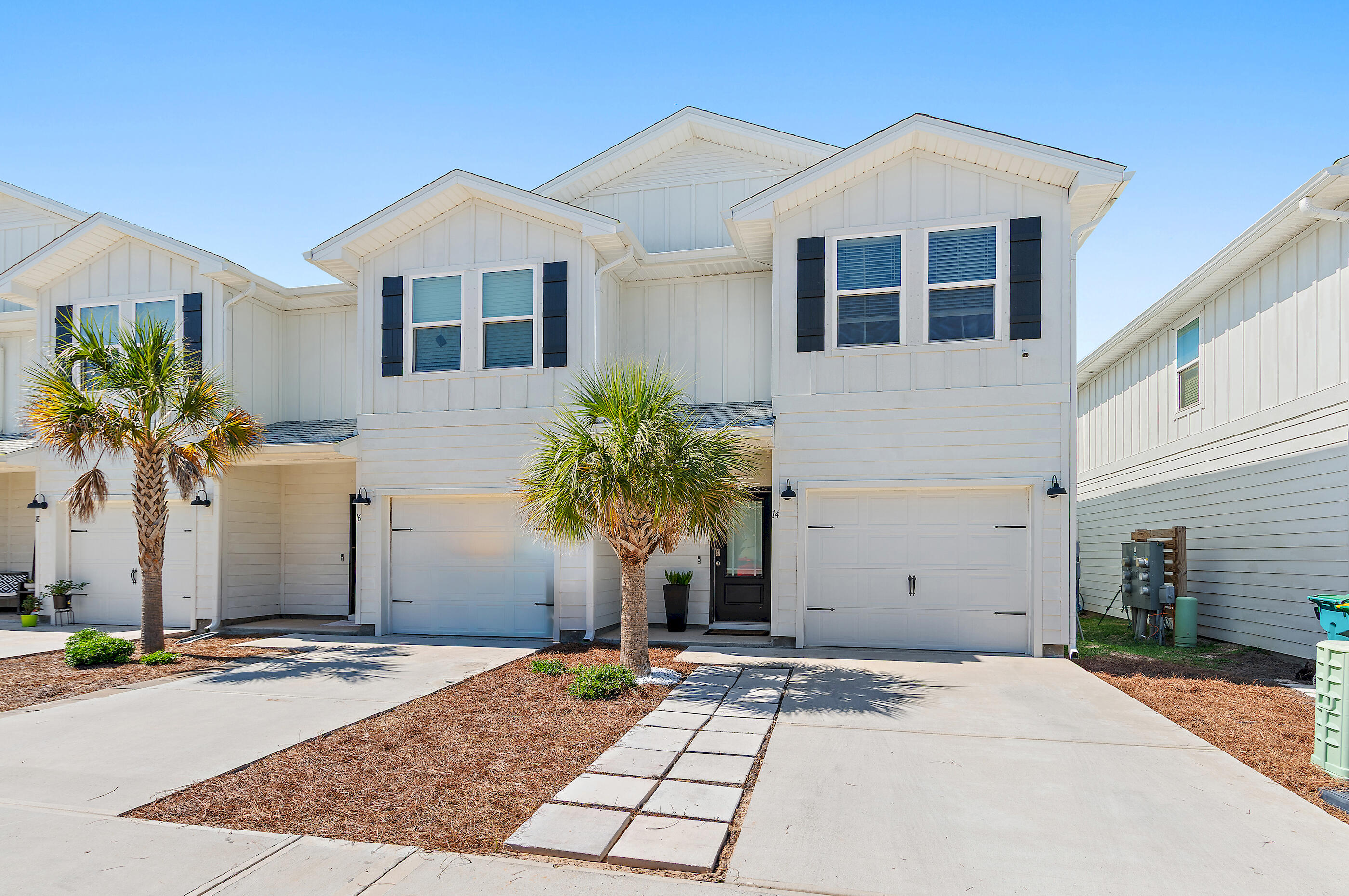 Experience coastal living at its finest in this beautifully upgraded corner townhome in the heart of Destin, with over $30,000 in upgrades. Just minutes from the beach, charming cafes, local restaurants and shopping. This thoughtfully customized home offers designer finishes. From the moment you arrive, the upgraded front and rear paver patio sets this home apart. Inside, every detail has been carefully selected to maximize both style and functionality. The spacious primary suite features a custom walk-in closet with built-in organization and a spa-inspired ensuite bath designed for relaxation. The kitchen has been enhanced with a stylish backsplash, pendant lighting, dimmer switches, pull-out pantry drawers, and a concealed trash cabinet--creating a space that is as practical as it is beautiful. Throughout the home, builder-grade wire shelving has been replaced with custom wood shelving, while professionally framed windows and custom window treatments add warmth and architectural character. The laundry room includes front-loading washer and dryer with custom cabinetry for additional storage. A custom stair runner adds elegance, while the living area showcases built-in cabinetry, floating shelves, bookshelves, and a mounted flat-screen television that conveys with the home. Every inch of this residence has been intentionally designed to create exceptional storage.