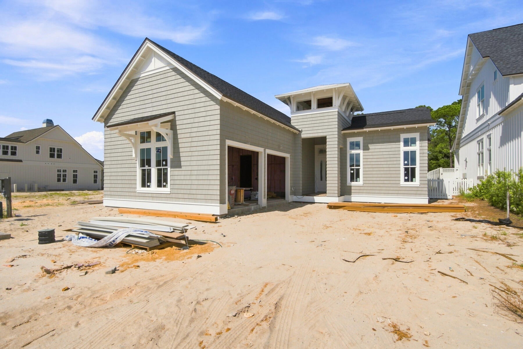 Under construction in Powell Landing East at Watersound Origins, the Rosecliffe II pairs distinctive coastal architecture with a highly functional single-level floor plan and a strong connection to outdoor living. This 2,609-square-foot residence offers four bedrooms, four-and-a-half baths, a two-car garage, 12-foot ceilings throughout, and engineered white oak flooring.

A defining feature of the home's exterior is Nichiha Premium shake cladding across the entire residence, an elevated material selection, paired with a 5V-crimp Galvalume metal roof in a natural finish. The shake profile gives the home a refined New England coastal aesthetic while adding texture and architectural character from every elevation.

Inside, the entry hall leads directly into the open kitchen, dining, and living spaces. The kitchen is finished with stained white oak cabinetry, champagne plumbing fixtures, Silestone quartz countertops, and GE Monogram appliances. A large center island provides generous workspace and seating while maintaining an open relationship with the dining and living areas.The living room is anchored by a 42-inch fireplace with stucco chimney, and a wall of 10-foot PGT sliding glass doors opens the main living space to the rear porch.

Outdoor living is an integral part of the design. The expansive covered porch extends across the rear of the main living area and features a 42-inch Isokern fireplace, creating a substantial outdoor gathering space overlooking the 15'x22' Gunite saltwater pool, integrated with a spa and two baja sunning decks. A large paver pool deck provides additional room for lounging and entertaining while maintaining a direct connection between the pool, porch, and interior living areas.

The primary suite is positioned at the rear of the home with direct access to the covered porch. Its bath includes dual vanities, a freestanding tub, walk-in shower with designer tilework and illuminated niche, separate water closet, and walk-in closet. Three additional bedrooms are arranged along the opposite side and front of the home, each with its own ensuite bath and closet, providing well-appointed accommodations for family and guests.

Everyday functionality is equally considered. A walk-in pantry is conveniently positioned near the kitchen, while the spacious laundry/mudroom provides cabinetry, workspace, additional storage, and direct access from the two-car garage. A powder room near the entry completes the floor plan.

Located in Powell Landing East, the home offers access to the amenities of Watersound Origins, including the Village Commons pool, fitness center, tennis and pickleball courts, sports courts, and miles of walking and biking trails, along with Origins Golf Course. Watersound Town Center is conveniently located near the community entrance with Publix, dining, medical services, Starbucks, and year-round events, while Hwy 98 provides easy access to 30A and Inlet Beach.

Estimated Completion: end-Nov '26