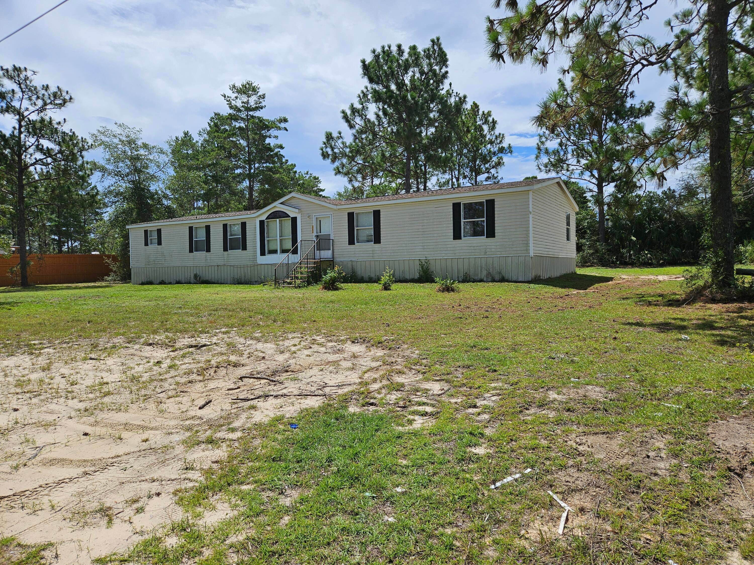 Bring your vision and unlock the potential of this roomy 2,052 sq. ft. home on 0.46 acres! Located in Oakwood Hills, this 2001 mobile home offers a spacious floor plan, a large yard, and endless possibilities for renovation. Whether you're looking for a primary residence, rental property, or investment opportunity, this home is packed with potential. Some repairs are needed, making it an ideal project for handy buyers or investors. Roof replaced 2020, A/C in 2022. Sold as-is.