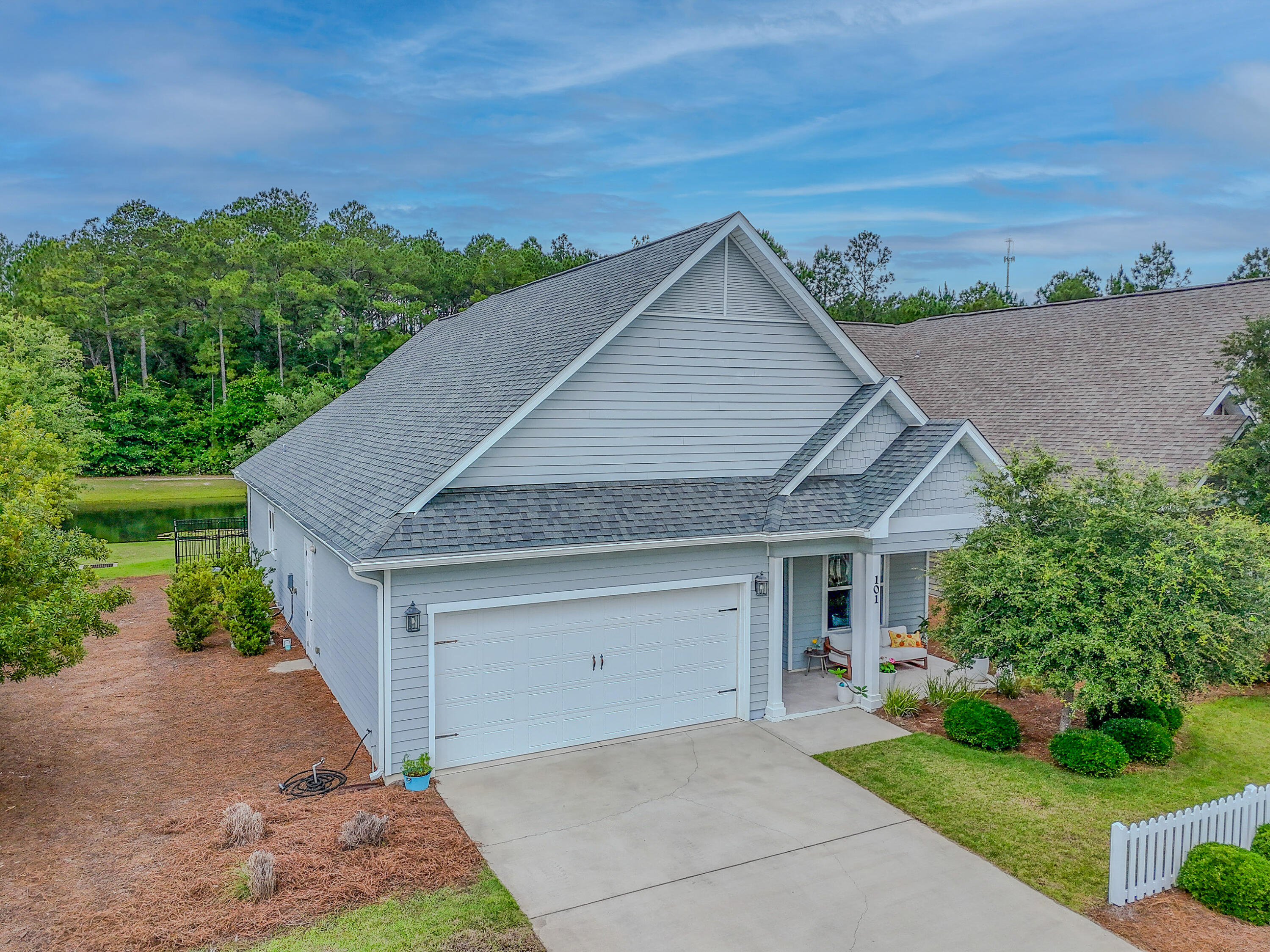CURRENTLY UNDER CONTRACT, SELLER WILL CONSIDER BACKUP OFFERS. Perfectly situated between Destin and Panama City Beach and just 10 minutes to the beautiful emerald beaches, this gorgeous 3-bedroom, 2.5-bathroom home is located in a charming low-density community and offers the perfect blend of coastal comfort and luxury. From the moment you walk through the front door, you're welcomed by an open floor plan filled with tons of natural light and relaxing pond views that can be enjoyed from nearly every room in the home. Gorgeous hardwood floors, shiplap accents, extra-wide baseboards, and crown molding add warmth and character throughout, while the stunning kitchen features granite countertops, stainless steel appliances, custom backsplash & shaker-style cabinets. The spacious first-floor primary suite offers peaceful water views, a beautiful ensuite bathroom and master closet while upstairs you'll find two additional bedrooms, a full bathroom, a convenient walk-in attic space and a second AC unit to keep both levels equally comfortable year-round.  Enjoy quiet mornings and relaxing evenings from the enclosed patio overlooking the water, all while being conveniently located close to Destin, 30A, and Panama City Beach!