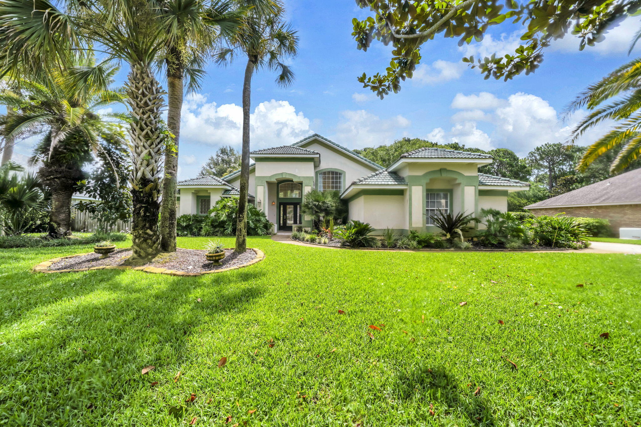 Opportunity awaits in the highly sought-after Golf Community of Indian Bayou! This spacious 3-Bedroom, 3- Bathroom pool home offers 2,312 square feet of Single-Level living on a private 0.33-acre lot backing to natural green space.

To make this opportunity even more attractive, the seller is Offering Significant Improvements with an acceptable offer, including a NEW Dimensional Shingle Roof, Pool Resurfacing, & repair of damaged Window Glass & Seals. This represents approximately $70,000 in VALUE to be completed prior to closing for added peace of mind. Bring your vision and personal touches to transform this home into your dream property.

Inside, the open-concept floor plan features multiple living & entertaining spaces with tile & luxury vinyl plank flooring throughout the common spaces. Upon entry, you'll find a formal living room & separate dining room connected by a convenient wet bar, creating the perfect setting for holiday gatherings, dinner parties, or hosting family & friends. The chef's kitchen is designed for entertaining or gathering with family with expansive granite countertops, bar seating, abundant cabinetry, a separate pantry, gas range, & stainless-steel appliances including an oversized French-door refrigerator, dishwasher, and microwave.

The main living areas boast soaring 18-foot ceilings, & a cozy gas fireplace, creating an impressive yet inviting atmosphere. Natural light pours through the home's many windows and sliding glass doors, (READ MORE) seamlessly blending indoor and outdoor living. Multiple sliding glass doors lead to the covered patio, which is already plumbed with natural gas for a future grill or outdoor kitchen, ideal for enjoying warm Florida evenings and weekend cookouts by the pool.

Step outside to a fenced backyard that backs to undeveloped natural green space, providing exceptional privacy and a peaceful backdrop rarely found this close to the heart of Destin. The freeform gunite pool with water feature offers the perfect foundation for creating your own outdoor oasis where you can spend afternoons soaking up the Florida sunshine, entertaining guests, or unwinding after a day at the beach or golf course.

The split-bedroom floor plan provides privacy for owners and guests alike. The oversized primary suite offers ample room for a sitting area, reading nook, home office, or hobby space. The en-suite bath features dual vanities, a large walk-in closet, jetted soaking tub, separate walk-in shower, and private water closet- creating a relaxing retreat. Two additional guest bedrooms are served by two full guest bathrooms, providing comfortable accommodations for family and friends.

Additional features include an interior laundry room, extra-wide side-entry garage with pull-down attic storage access, oversized driveway, and double gates providing convenient backyard access and storage space for watercraft or additional vehicles. Whether you enjoy boating, paddleboarding, fishing, or simply taking advantage of all that the Emerald Coast has to offer, this property provides the flexibility to support your lifestyle.

Located in one of Destin's most desirable golf communities, residents enjoy a central location close to shopping, dining, entertainment, and outdoor recreation. Spend mornings on the golf course, afternoons at the beach, and evenings enjoying Destin's renowned waterfront restaurants and coastal sunsets. Just minutes from Indian Bayou's executive 18-hole golf courses and only 2.3 miles from the sugar-white sands of the Gulf of Mexico and Henderson Beach State Park, this home offers the perfect blend of privacy, recreation, and the coveted Destin lifestyle. Eligible for VA and conventional financing. Don't wait, Call your Realtor today to schedule a showing or virtual tour!