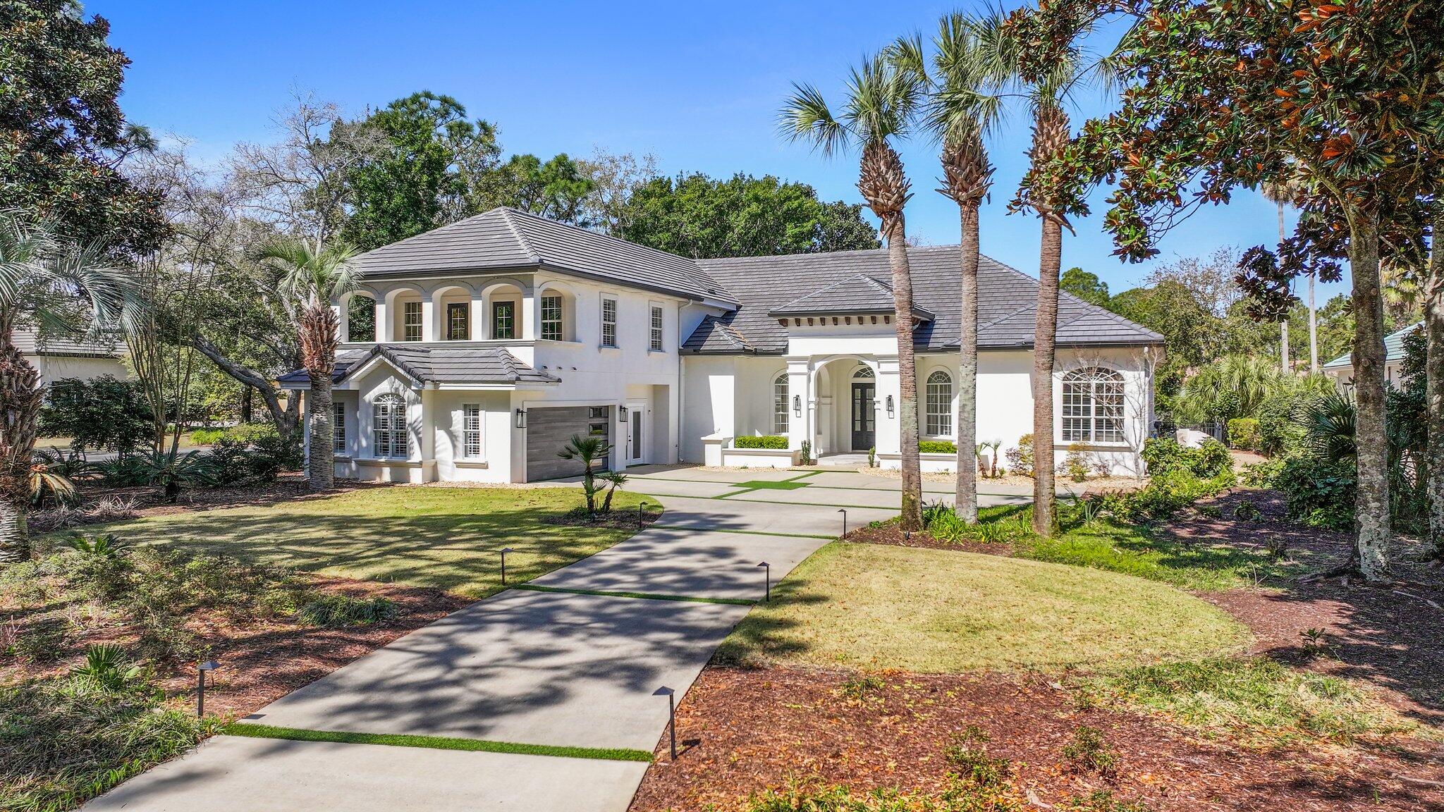 Elegantly positioned on a rare oversized waterfront corner lot in the gated golf community of Regatta Bay, this modern coastal retreat offers a unique blend of privacy, space, and serene water views. Tucked away with generous spacing from neighboring homes, the setting creates a peaceful, private feel within the community.

Originally selected as one of Regatta Bay's premier model lots, this homesite was chosen to showcase the very best of the neighborhood, a true testament to its exceptional positioning, privacy, and long-term desirability.
The five-bedroom residence is filled with natural light, featuring tall ceilings, expansive windows, and thoughtfully selected designer finishes throughout including a one-of-a-kind Murano chandelier, quartz countertops, and a chef's kitchen  with professional-grade appliances. Multiple living spaces, a formal dining area, dedicated office, and a spacious upstairs bonus room that provides flexibility for both entertaining and everyday living.

Outdoor living is where this property truly stands out set on a 0.59-acre waterfront parcel with mature trees, a heated pool and spa, summer kitchen, and a private dock perfect for enjoying the water, whether it's a quiet morning or hosting guests.
Located just minutes from Destin's top dining, shopping, and the white sand beaches of the Emerald Coast, this home offers a standout lifestyle in one of the area's most desirable gated communities.