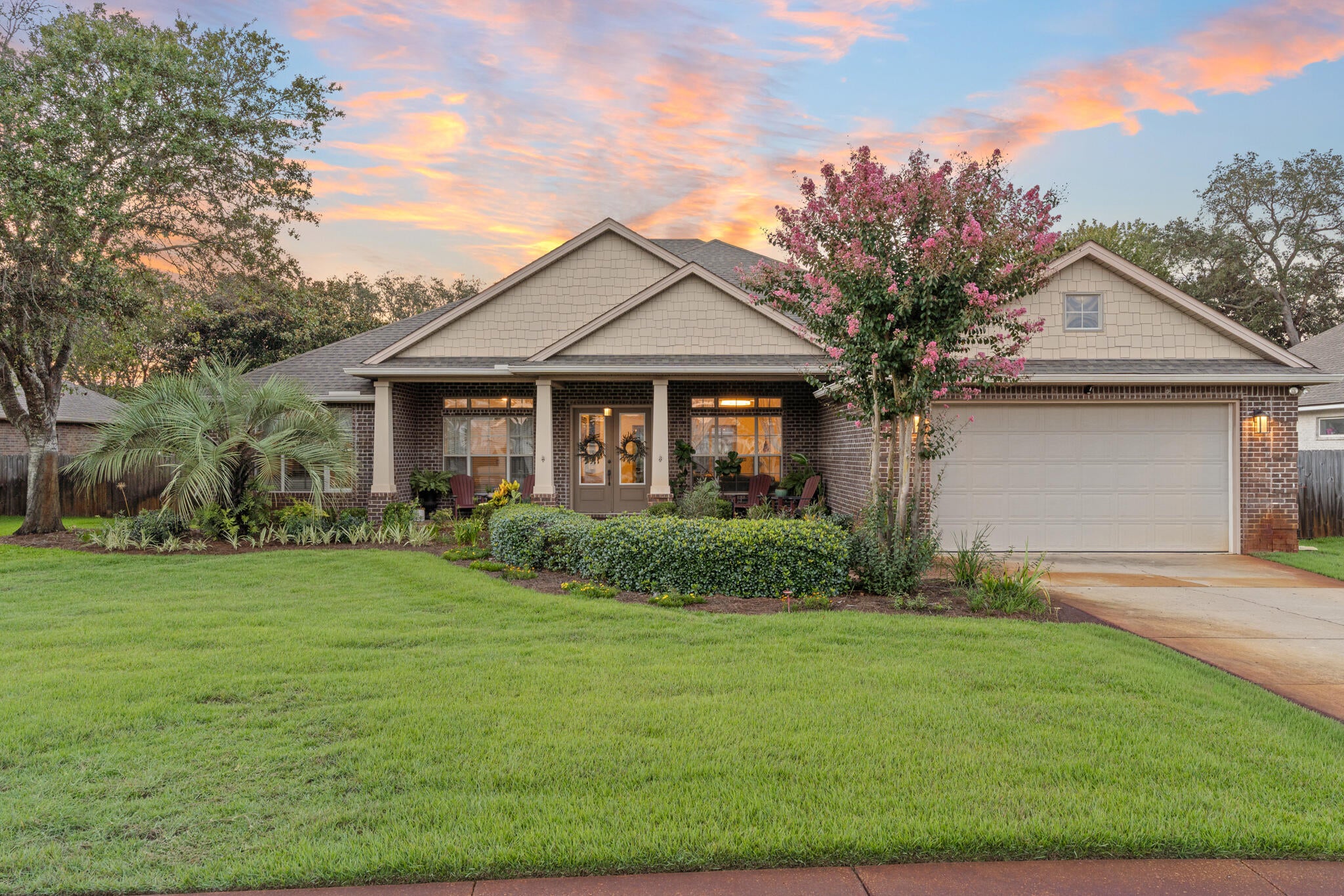 4118 Indian Byu N is a rare five-bedroom home tucked away off Indian Trail, a coveted, HOA-free neighborhood in West Destin. This single-story brick home has been remodeled from the inside out to bring people together in an upscale modern setting. Offering 3,216 square feet of reimagined interior space, plus more than 500 square feet of covered porch and screened patio, it is a home built for pool days, s'mores by the fire, and easy, everyday living.

This all-brick home features a deep Craftsman-style front porch with tapered square columns, a gabled roofline, and shaker shingle accents. French-style glass doors open into a bright, open-concept great room with 10-foot tray ceilings and natural light pouring through transom-topped windows. Multi-panel sliding glass doors lead out to the screened porch, making indoor-outdoor living easy.

Reimagined with modern functional purpose in mind, the formal dining room was transformed into a sophisticated library-inspired parlor, with floor-to-ceiling built-ins and a stylish wine bar that creates an intimate spot to unwind with a good book and your favorite beverage. The parlor flows into the grand living room, anchored by a contemporary entertainment center complete with a sleek linear fireplace and floating shelves, all made for movie nights and long conversation.

Anyone who enjoys cooking is sure to fall in love with the chef-inspired kitchen at the center of the home. The oversized island seats six to eight and offers generous  prep space, soft-close cabinetry, new stainless appliances, granite counters, and a walk-in pantry, with plenty of room to host a gathering. A dedicated laundry/utility room, with space for a second refrigerator, keeps entertaining effortless.

The home's smart split floor plan gives everyone room to spread out. The private primary suite is tucked at the rear, a serene escape with 9-foot tray ceilings, a custom walk-in closet, and a spa-like bath with dual vanities, an oversized walk-in shower, and a garden tub. Four guest bedrooms are positioned for privacy, with two at the front sharing a hall bath and two more guest rooms toward the rear of the home with an additional full hall bath. The far rear bedroom opens directly to the pool and would be an ideal mother-in-law or guest quarters.

Outside is where this home really shines. The screened covered porch is perfect for cool winter afternoons, summer evenings, and all the days in between. With custom stamped concrete and a wet bar, it is inviting for year-round use. Beyond it, the backyard features a heated in-ground Gunite pool, a paver deck, and a firepit made for gathering around under the Florida stars. The lot is beautifully landscaped with plants native to Florida, lush green grass, and a spacious side yard with room enough to park a recreational vehicle behind the privacy fence.

Move-in ready and minutes from Choctawhatchee Bay, the sugar-white beaches of the Emerald Coast, and the heart of Destin, this single-story home offers something increasingly hard to find: a newer modern build, functional design, and space to make memories.