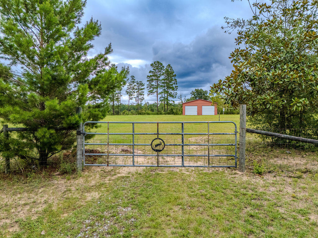 Don't miss this one-of-a-kind opportunity! Prime properties like this rarely come on the market. This beautifully maintained 1.5-acre lot is completely cleared, fully fenced, and ready for its new owners with power and water already connected.
The property features a spacious 28' x 28' metal building on a concrete slab with three roll-up doors, providing plenty of room for storing equipment, vehicles, or recreational toys. A 30-amp RV hookup is also installed.
Property is just one mile from the Juniper Lake boat ramp, offering quick and easy access to the lake, and 5 miles to beautiful historic downtown and Lake Defuniak.
As an added bonus, the property also includes pecan and chestnut trees.  If you're looking for a place to build your dream home, and have room to store all your toys, this unique property is ready for you.