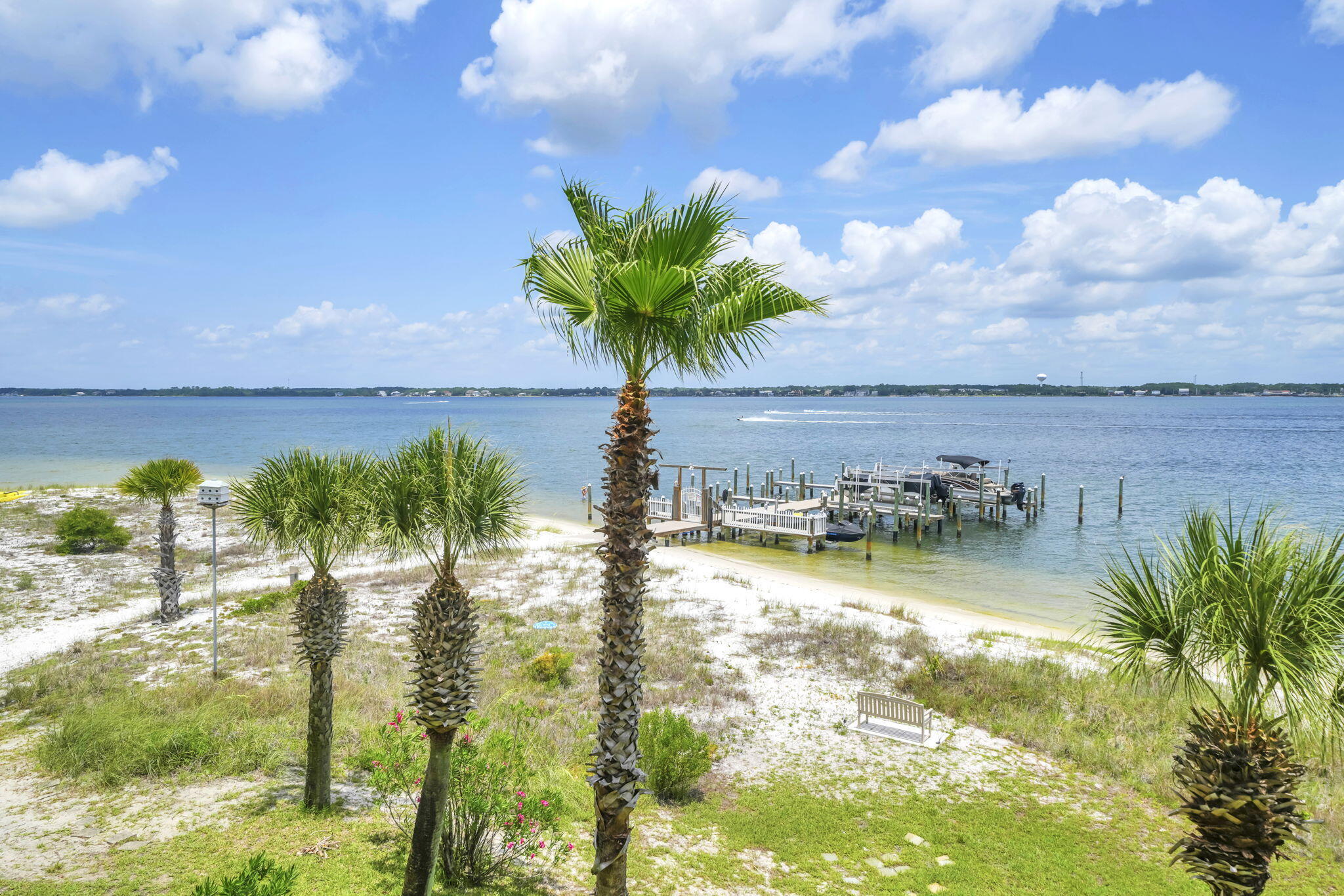 This must be living in PARADISE... welcome to PARADISE POINT on Navarre Beach!
Situated at one of the highest elevations on Navarre Beach, Paradise Point offers an incredible opportunity for those who love boating, water views, and coastal living. Located directly on the Intracoastal Waterway and only a half block from the Gulf Islands National Seashore, plus nearby restaurants and local favorites, this location truly delivers the best of beach life.
This spacious 3-story townhome features 3 bedrooms, 3.5 bathrooms, and your very own private deep-water boat slip--making days on the water effortless.
The ground level offers a blow-out design beneath the living area with easy access to the 1-car garage, ample storage for beach gear, and direct access to the backyard and Intracoastal.
The first living level includes a versatile guest bedroom that could also serve as an ideal home office.
On the main living floor, you'll find an open-concept layout designed to maximize water views. The kitchen features granite countertops, abundant cabinetry, a full laundry room, and additional storage space. The kitchen overlooks both the dining and living areas, all with beautiful views of the Intracoastal. Step outside through the sliding glass doors onto the expansive covered balcony--perfect for entertaining friends and family or simply relaxing while watching boats pass by. A convenient half bath completes this level. Upstairs are two generously sized ensuite bedrooms, including the primary suite, both offering excellent closet space and privacy. Primary bedroom has a waterview of the Intercoastal/Navarre Sound. 
Throughout the home, you'll appreciate the thoughtfully designed hidden storage spaces that maximize functionality.

Additional features include:

Private deep-water boat slip
3 dedicated parking spaces (1 garage, 1 driveway, 1 deeded space)
Additional overflow guest parking
Community pool
Roof replaced in 2024
Elevation certificate available in documents

HOA: $800/month and includes:
  Roof
  Exterior maintenance
  Insurance
  Grounds maintenance
  Trash service
  Community pool

Rental restrictions: No short-term rentals permitted. Minimum rental period is 30 days.

New Buyer Fee: $800
Dock Transfer Fee: $963

Home will convey fully furnished LESS all wall art. 

Home is handicap friendly.

Come experience the relaxed waterfront lifestyle that makes Paradise Point one of Navarre Beach's hidden gem.