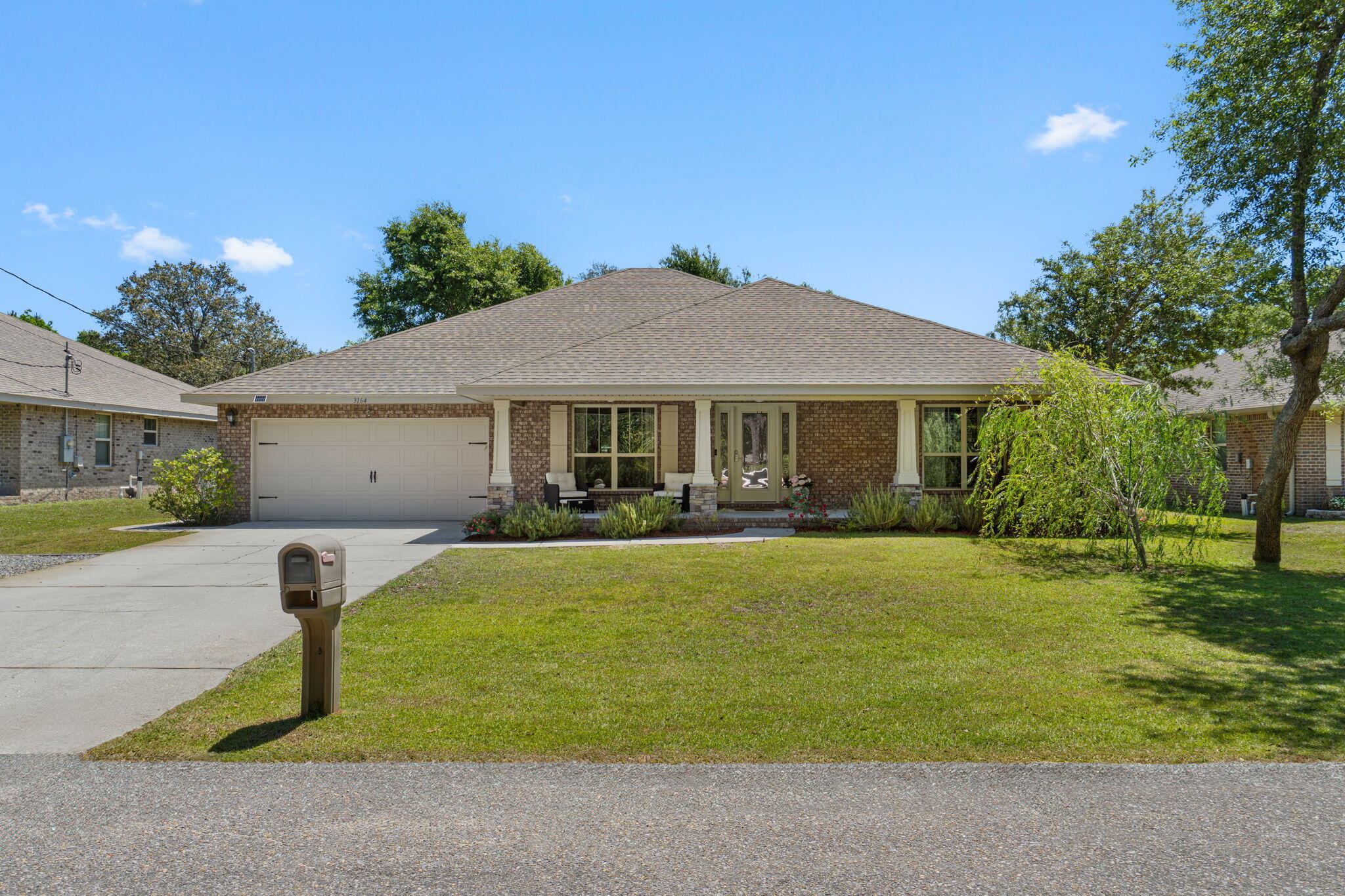 Welcome to your own slice of peaceful Florida living! Built in 2018 and situated on a spacious .36-acre lot in a quiet Navarre neighborhood, this stunning 5-bedroom, 3-bathroom home offers 2,685 square feet of beautifully designed living space with the perfect blend of comfort, functionality, and lifestyle. From the moment you arrive, the inviting curb appeal, oversized front porch, and beautifully maintained landscaping set the tone for what's inside. Relax and unwind on the incredible covered front porch featuring THREE ceiling fans, creating the perfect place to enjoy your morning coffee or evening sunsets. The property also includes rosemary in the front yard along with blackberry bushes in both the front and backyard, adding charm and character to this already special property. Step inside and immediately notice the soaring ceilings, elegant archways, and spacious open-concept layout that make this home feel both grand and welcoming. The heart of the home is the oversized kitchen featuring abundant counter space, a massive breakfast bar, and seamless flow into the main living area, making it ideal for entertaining, hosting holidays, or simply enjoying everyday life. A formal dining room adds even more flexibility and style. The thoughtfully designed split-bedroom floor plan offers privacy and functionality for families or guests alike. The spacious primary suite is tucked away on one side of the home and features tray ceilings, dual vanities, a soaking tub, separate shower, and a large walk-in closet. Two additional bedrooms are connected by a convenient Jack-and-Jill bathroom, while the opposite side of the home offers two more bedrooms and another full bath. The screened back porch creates an incredible outdoor living space with removable three-season screens, allowing you to enjoy the outdoors year-round. The oversized backyard offers endless possibilities with plenty of room to add your dream pool, outdoor kitchen, or backyard oasis. A clean and well-maintained storage shed provides additional storage. Additional features include a dedicated RV pad with a 50-amp hookup, perfect for storing your camper, motorhome, or travel trailer with convenient on-site power access. Located just a few streets from the Holley Boat Ramp and less than a mile from the Navarre Equestrian Center offering horseback riding lessons, this home is perfectly positioned for those who love the outdoors and peaceful living while still being conveniently close to shopping, dining, schools, and local amenities without all the heavy traffic and congestion. This home is the total package... spacious, beautifully maintained, thoughtfully designed, and loaded with lifestyle features buyers are searching for. Truly a Navarre showstopper!