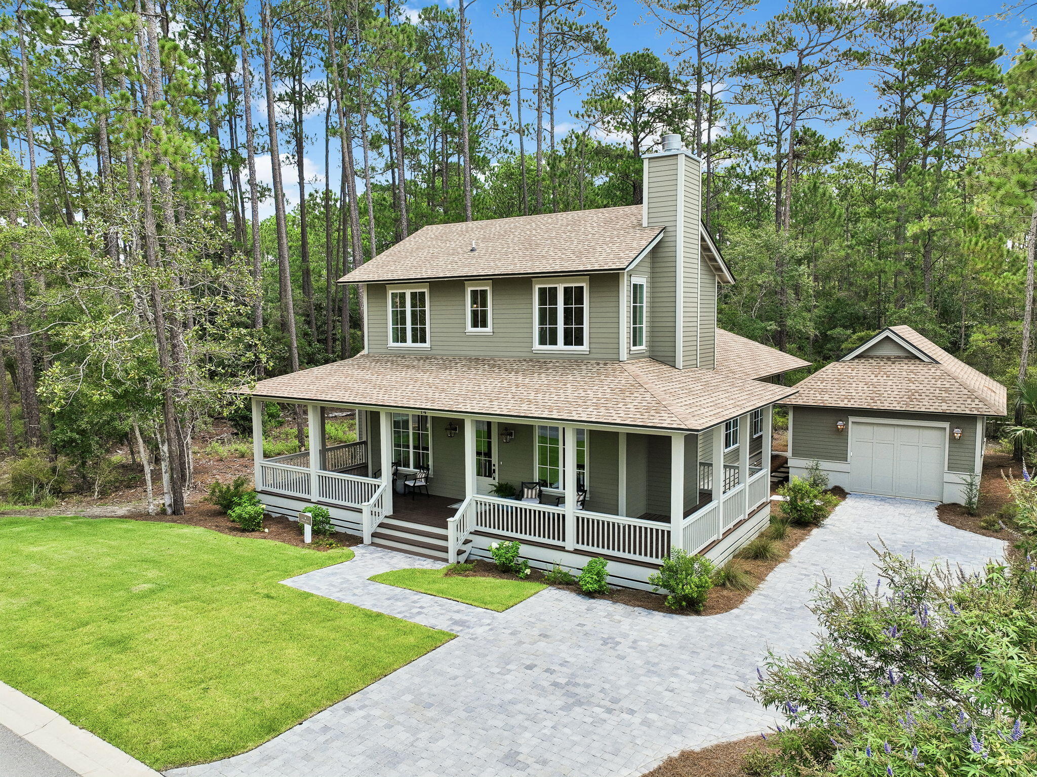 Welcome to 14 Glade Boulevard, an elegant Lowcountry-inspired residence in Oak Grove at Eden's Landing, Point Washington's premier luxury community. Thoughtfully designed with three bedrooms, three-and-a-half bathrooms, and gracious indoor and outdoor living spaces, this home blends timeless Southern character with modern coastal comfort.

A welcoming wraparound front porch sets the tone, offering the perfect setting for morning coffee, afternoon conversation, and relaxed evenings. Inside, the entry is flanked by a formal dining room and a private den, creating beautifully defined spaces for entertaining, working from home, or unwinding. The heart of the residence is the expansive great room, where a spacious living area flows seamlessly into a chef-inspired kitchen designed for both everyday living and effortless entertaining. A generous mudroom and butler's pantry provide additional storage, organization, and functionality just off the kitchen.

The main-level primary suite offers a private retreat with separate closets and a beautifully appointed bath featuring a large walk-in shower, freestanding soaking tub, and dual vanity. Upstairs, two additional guest suites each include a private en suite bathroom, offering comfort and privacy for family and visitors.

Outdoor living continues at the rear of the home with an additional covered porch overlooking a welcoming firepit area--an ideal setting for gathering with friends and enjoying evenings beneath the trees. An oversized detached single-car garage completes the property with ample space for parking, storage, bikes, and beach gear.

Surrounded by the natural beauty and historic charm of nearby Eden Gardens State Park, Oak Grove at Eden's Landing offers a rare combination of privacy, architectural distinction, and convenience. The community is ideally positioned between the sugar-white beaches and celebrated towns of Scenic Highway 30A and the boating, fishing, and recreation of Choctawhatchee Bay. Seaside, WaterColor, and the dining, shopping, and lifestyle of 30A are all just minutes away.

Whether enjoyed as a full-time residence or a refined coastal retreat, 14 Glade Boulevard captures the very best of Point Washington living--where timeless architecture, natural surroundings, and modern luxury come together.