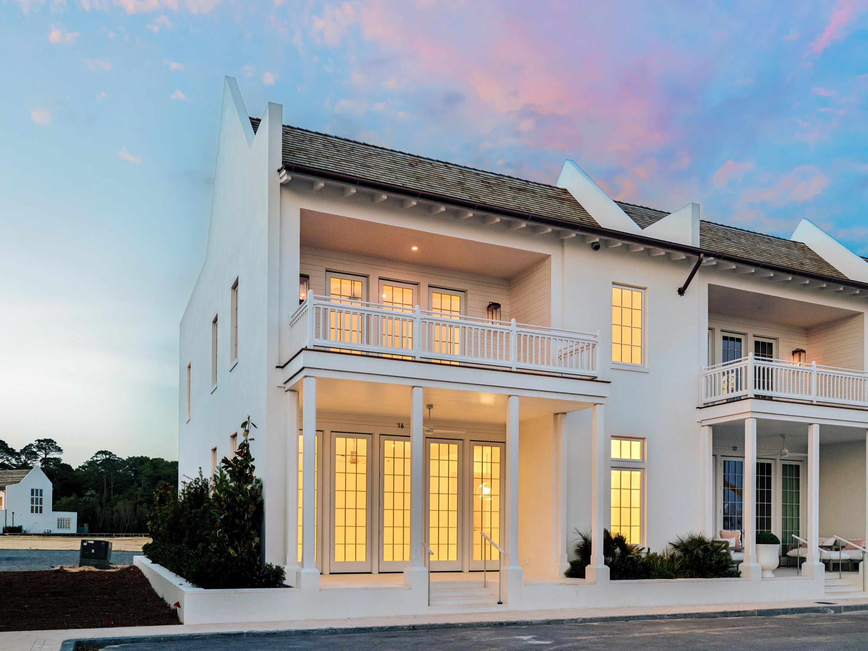 Positioned as a rare end-cap townhome within the Array community along Scenic Highway 30A offers enhanced privacy and abundant natural light in a refined coastal setting. In the heart of the Emerald Coast with deeded beach access nearby, Unit 16 at 29 Astra Way presents a sophisticated ownership opportunity and is offered unfurnished for complete personalization. The exterior features crisp white stucco, cedar shake roofing, columned porticoes, and a private upper-level balcony overlooking the surrounding preserve.Inside, wide-plank European oak flooring, floor-to-ceiling French doors, and transom windows create a bright, open living space with tranquil preserve views. The kitchen features custom cabinetry, quartzite slab surfaces, and a waterfall-edge island, complemented by a built-in dining nook.A skylit staircase leads to well-proportioned bedroom suites with spa-inspired Carrara marble bathrooms featuring frameless glass showers, soaking tubs, and floating vanities.

The upper terrace with hardwood decking and white balustrades overlooks the preserve and future amenity corridor, offering a peaceful outdoor setting.

Additional highlights include a private garage, enhanced privacy and light from its end-cap positioning, and close proximity to deeded beach access leading to the Gulf's sugar-white shoreline