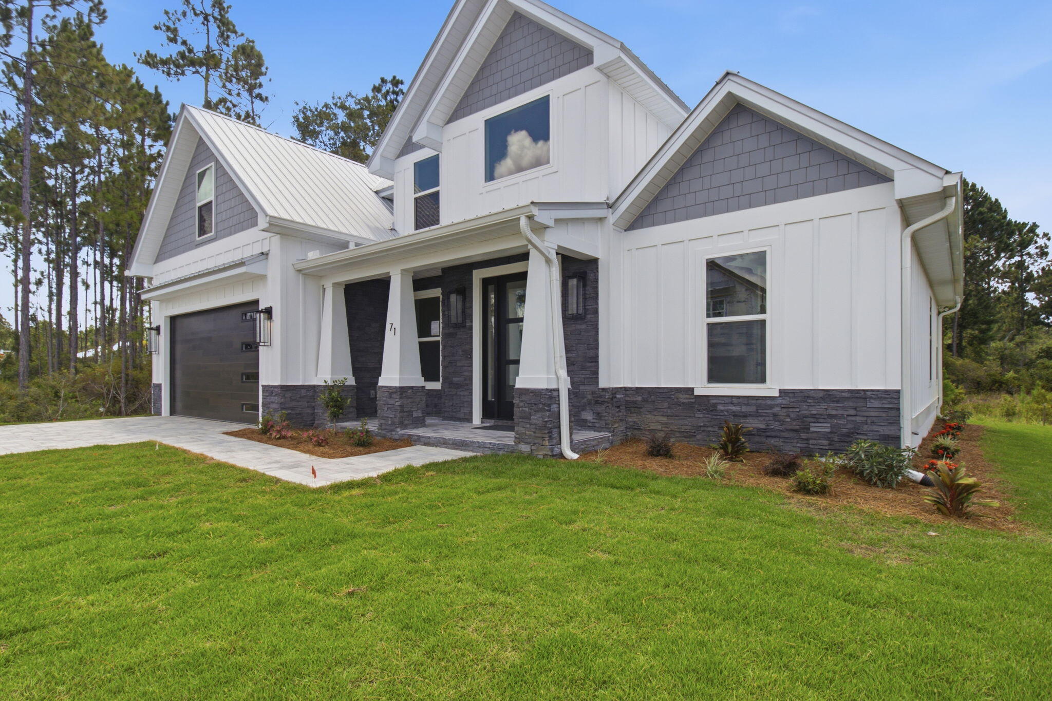 Welcome to a prime example of custom craftsmanship. This just completed home is located only moments from the pristine white sands of the 30A beaches. Spanning 2,505 square feet, this residence exudes refined coastal elegance through high-impact glass windows and doors, rich hardwood flooring, and designer finishes. Designed for both grand entertaining and effortless daily living, the main level features a dedicated executive office, while the upper level opens to a versatile flex loft--ideal for an opulent media lounge, play zone, or creative studio. At the home's center, a culinary kitchen impresses with custom quartz countertops, a premium appliance suite with dual gas/electric cooking capabilities, and a dedicated beverage station. The sun-drenched living room anchors the home around a cozy fireplace, seamlessly transitioning through glass doors to a serene, screened in patio overlooking lush natural surroundings. The first-floor primary bedroom sanctuary serves as a private spa-like retreat, highlighted by a freestanding soaking tub, a frameless glass rainfall shower, and polished brushed-gold hardware. Framed by cultured stone accents, this exceptional home offers an luxury coastal lifestyle, complete with access to resort-style community amenities including sparkling pools, pickleball, tennis and basketball courts along with a workout room, playground and scenic walking trails. Bear Creek is minutes from the Beaches of South Walton & Grady Brown Park on the bay.