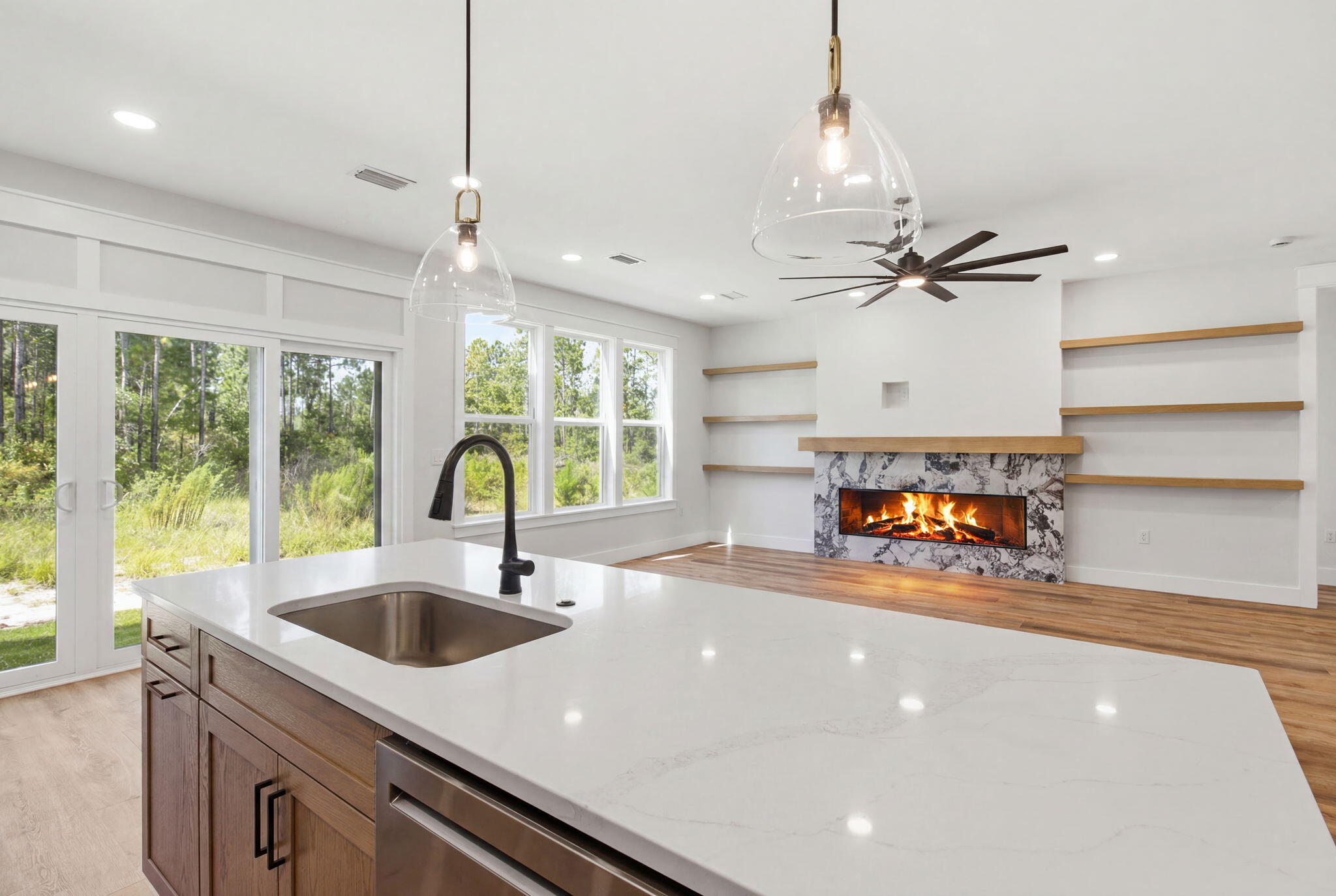 Welcome to a prime example of custom craftsmanship. Up to $5,000 in Flex Money when using Preferred Lender. This just completed home is located only moments from the pristine white sands of the 30A beaches. Spanning 2,505 square feet, this residence exudes refined coastal elegance through high-impact glass windows and doors, rich hardwood flooring, and designer finishes. Designed for both grand entertaining and effortless daily living, the main level features a dedicated executive office, while the upper level opens to a versatile flex loft--ideal for an opulent media lounge, play zone, or creative studio. At the home's center, a culinary kitchen impresses with custom quartz countertops, a premium appliance suite with dual gas/electric cooking capabilities, and a dedicated beverage station. The sun-drenched living room anchors the home around a cozy fireplace, seamlessly transitioning through glass doors to a serene, screened in patio overlooking lush natural surroundings. The first-floor primary bedroom sanctuary serves as a private spa-like retreat, highlighted by a freestanding soaking tub, a frameless glass rainfall shower, and polished brushed-gold hardware. Framed by cultured stone accents, this exceptional home offers an luxury coastal lifestyle, complete with access to resort-style community amenities including sparkling pools, pickleball, tennis and basketball courts along with a workout room, playground and scenic walking trails. Bear Creek is a gated community ... located just minutes from the Beaches of South Walton & Grady Brown Park on the bay.
