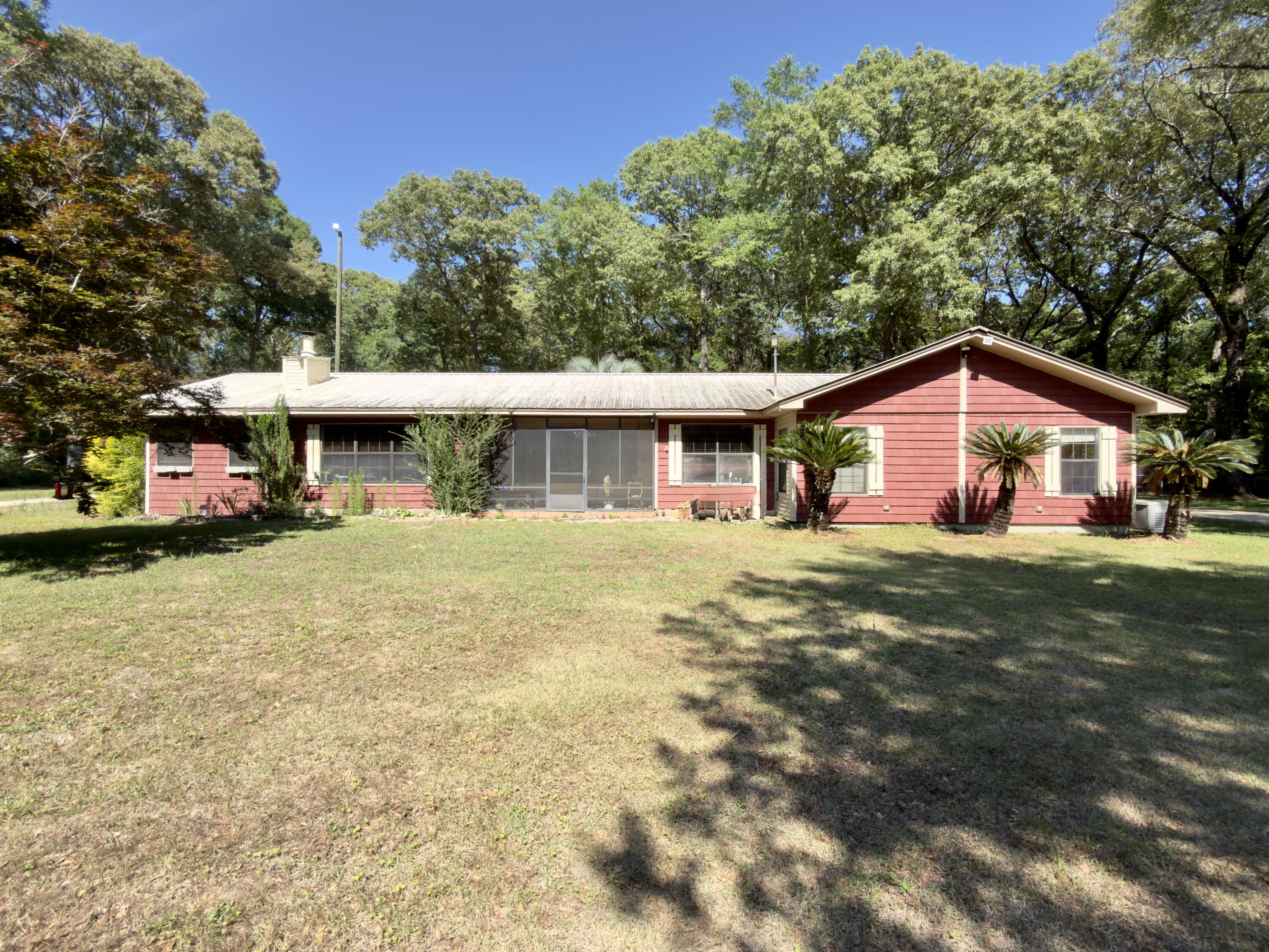 Whether you're looking for room for a small family estate or a savvy investment opportunity, this property offers space, versatility, and potential. Nestled on over an acre of solitary country land, this 1991-built home offers rural living without sacrificing convenience. You will find a very impressive collection of outbuildings designed for both work and play; all buildings and workshops are powered totaling 5 bays worth of carports which are ready for home businesses, hobbies or storage for boats, cars and toys. These do not include the large operational chicken coop, a 3rd storage building/workshop and another detached office space with 1/2 bath that could be space for that still living at home grown child, in-law suite or guest house.  More expansive than this near 2500 square foot -  home suggests - Inside you will find split bedroom design with a large master bedroom and master bath - complete with a large garden tub, tiled shower and a private hot tub room. The remaining 4 bedrooms and bath feel like the west wing of this home and offer large rooms, additional privacy from the main home and tons of potential. Bring your vision and make this country gem your own!