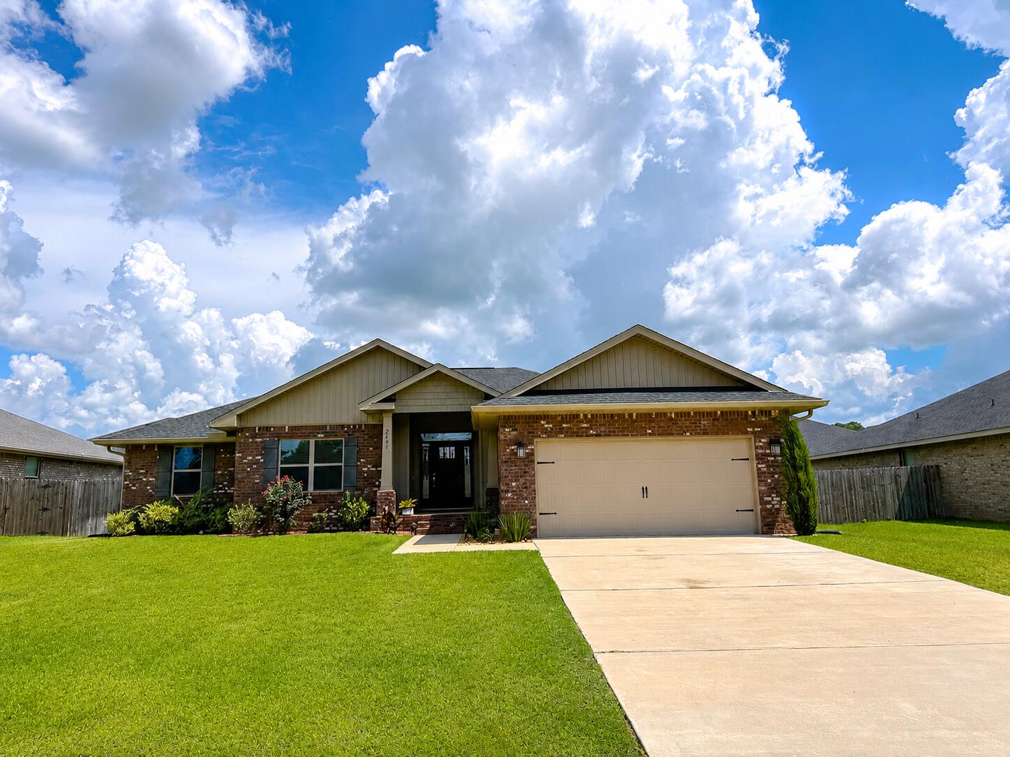 Why wait to build when you can move right into this beautifully maintained 2024 Craftsman-style home in the desirable Silvercrest community of North Crestview? Offering 2,105 square feet of thoughtfully designed living space, this 4-bedroom, 2-bath residence combines modern finishes, an open layout, and everyday functionality.

Step inside to discover elevated ceilings, luxury vinyl plank flooring throughout the main living areas, and an inviting open-concept design that's perfect for entertaining or spending time with family. The spacious kitchen is the heart of the home, featuring granite countertops, abundant cabinetry, a large center island with bar seating, stainless steel appliances, and seamless flow into the dining and living areas.

The split-bedroom floor plan provides privacy, with the generously sized primary suite tucked away from the guest bedrooms. Enjoy tray ceilings, two walk-in closets, a spa-inspired ensuite featuring dual vanities, a relaxing garden tub, and a separate walk-in shower.

Step outside to the covered back lanai overlooking a fully fenced backyard with a wood privacy fence--ideal for children, pets, backyard cookouts, or simply relaxing after a long day. Additional features include a four-sided brick exterior, sprinkler system, two-car garage, and low-maintenance landscaping. Located in the quiet Silvercrest community with a low HOA of just $350 annually, you'll enjoy convenient access to Publix, shopping, restaurants, schools, and major commuting routes. Duke Field is approximately 15 miles away, while Eglin Air Force Base is approximately 26 miles away, making this an excellent option for military personnel and commuters alike.

Move-in ready and offering the peace of mind that comes with nearly new construction, this home delivers the perfect combination of quality, comfort, and convenience.