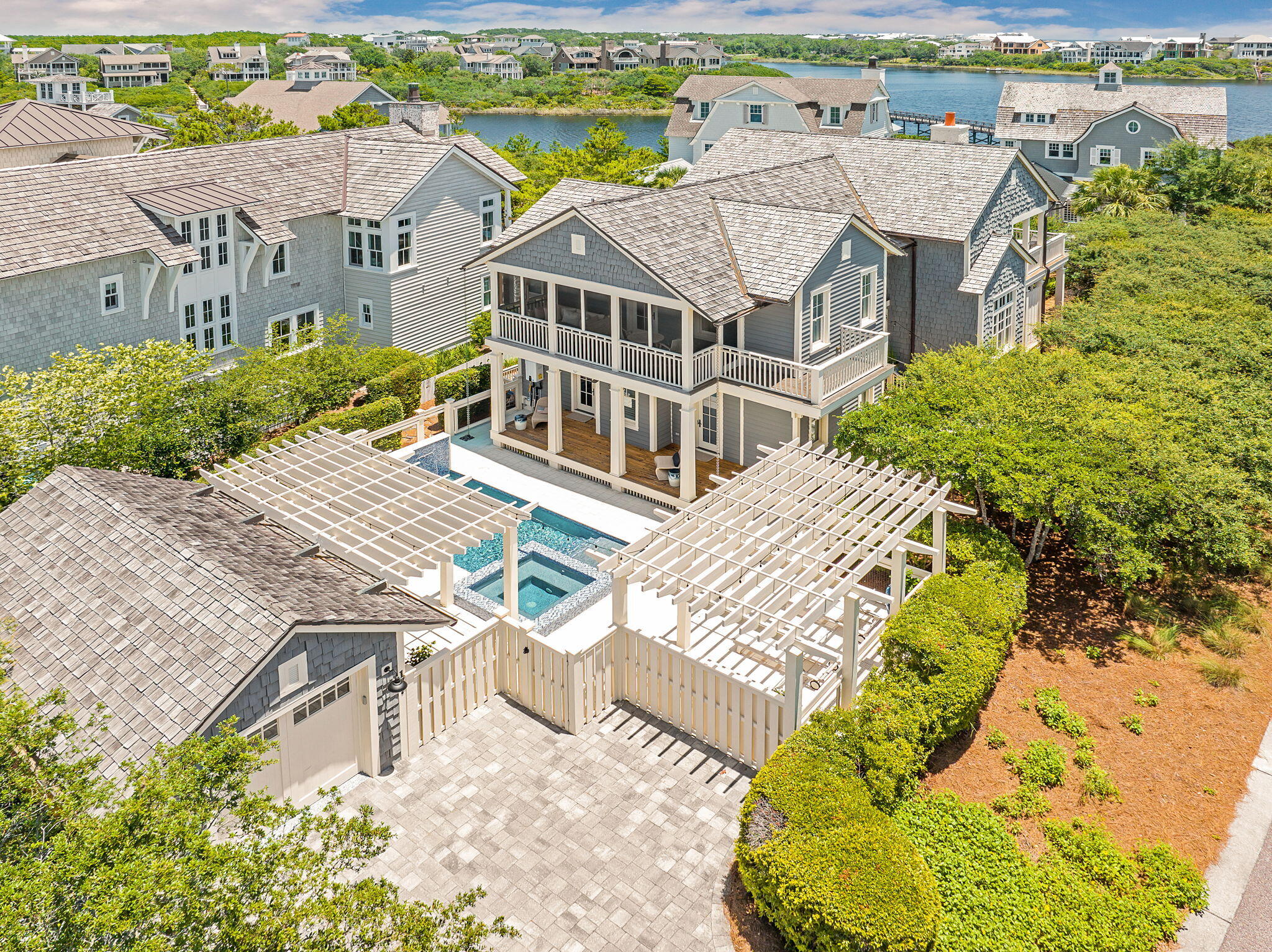 Welcome to 177 Tidal Bridge Way, a rare coastal gem located in the heart of the exclusive, gated community of WaterSound Beach. Positioned on one of the largest and most private lots in the neighborhood, this architecturally striking Cape Cod-style home is wrapped in natural cedar shingles with a matching cedar shingle roof, evoking the timeless elegance of a classic Hamptons retreat--yet just steps from the sugar-white sands of Florida's Emerald Coast.
Built in 2006 by the esteemed Chase Building Group and meticulously maintained by its one and only owner, this four-bedroom, four-and-a-half-bath residence spans approximately 3,039 square feet and sits on a lushly landscaped corner lot. Mature indigenous oaks and professionally designed gardens frame the home, providing both beauty and privacy. A charming side courtyard features a built-in gas fire pit surrounded by lounge chairs an ideal setting for evening gatherings after a day at the beach. And when you're ready to unwind, the private pool and spa offer a peaceful oasis just outside your door.
Boasting a coveted second-tier location with views of both Camp Creek Lake and the Gulf of Mexico, the home is surrounded by seven fully covered porches including two that are screened offering endless opportunities for outdoor living. Whether enjoying sunrise coffee on the front porch, sunset cocktails on the upper deck, or relaxing by the pool, every space has been thoughtfully designed to celebrate the surrounding natural beauty.
Inside, the home has been completely updated with luxury finishes and custom craftsmanship. The professionally designed kitchen is a true showpiece, with natural marble countertops, bespoke cabinetry handcrafted by local artisan Grimes Cabinets, and top-tier appliances by Thermador and Sub-Zero. A built-in Thermador coffee machine is thoughtfully positioned near the primary suite perfect for a quiet morning ritual.
Both primary suites one on each floor have been reimagined with exquisite Calacatta Gold marble, freestanding soaking tubs, custom vanities, walk-in showers, and Kohler fixtures. Every bath in the home has been professionally remodeled to match the elevated aesthetic. The vaulted great room features exposed natural beams, a gas fireplace with marble surround, and one-of-a-kind custom cabinetry, creating a warm and refined living space ideal for both intimate evenings and entertaining guests.
Function meets form with a spacious paver-covered driveway, an oversized single-car garage with a vaulted ceiling for exceptional storage, and ample guest parking. The home is just a short stroll to WaterSound's private beach access, tranquil coastal dune lake, and the exclusive WaterSound Beach Club. With walkability to all of these prized amenities, it's no exaggeration to say: it's all about the location.
Whether you're seeking a serene primary residence, a luxurious vacation home, or an investment-grade property in one of the Gulf Coast's most desirable communities, 177 Tidal Bridge Way offers the rare combination of privacy, elegance, craftsmanship, and walkable beach lifestyle all behind the gates of WaterSound Beach.