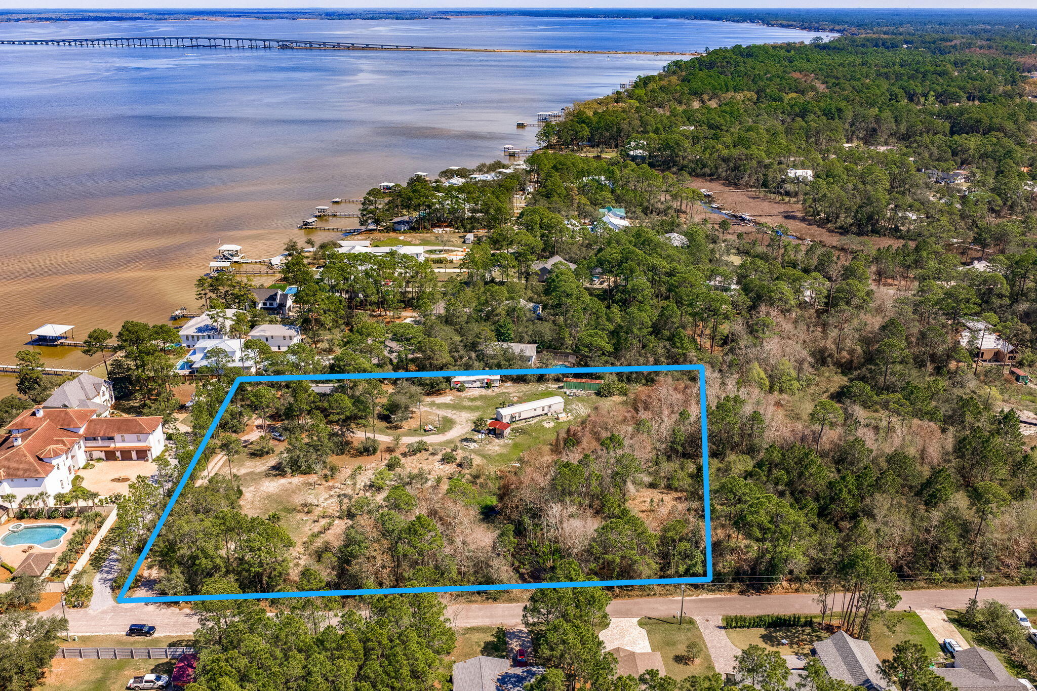 Tucked away on a quiet residential road, this beautiful 10-acre parcel located at 184 N Eden Park offers the perfect blend of privacy, natural surroundings, and prime location in Santa Rosa Beach. Zoned ''Small Neighborhood,'' the property allows up to 4 dwellings per acre--ideal for development, investment, or creating a private family compound. Partially wooded for added seclusion and charm, this property is just one block from the serene waters of Choctawhatchee Bay, offering easy access to coastal living.  Parcel contains 11.55 acres total and seller will sell 10-acres of the parcel and seller will retain 1.55-acres with a lot split at closing.  SELLER FINANCING AVAILABLE WITH CONSIDERABLE DOWN PAYMENT.