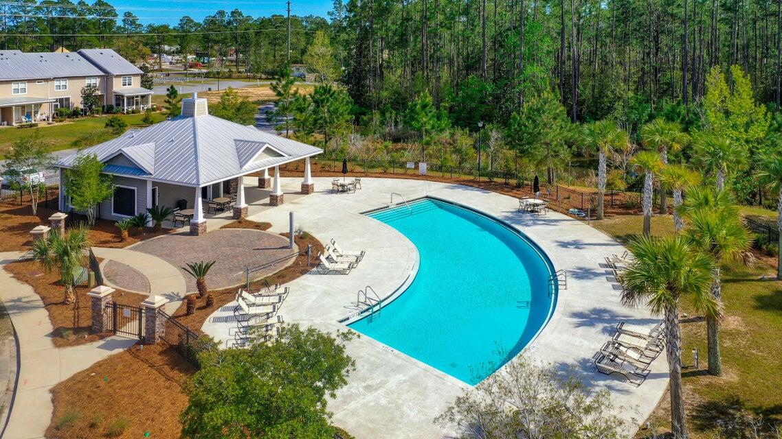 Beautifully maintained, thoughtfully designed townhome in the highly desirable Verandas at Freeport, offering low-maintenance living just minutes from Scenic Highway 30A, Choctawhatchee Bay, shopping, dining, and Florida's Emerald Coast beaches. The popular Savannah floor plan features an open-concept design with a spacious living area, well-appointed kitchen with island seating, stainless steel appliances, abundant cabinet space, and seamless flow for everyday living or entertaining. The spacious primary suite offers a walk-in closet, dual vanities, and an oversized bath, while the additional bedrooms provide flexibility for guests, a home office, or hobbies. Residents enjoy outstanding community amenities, including a clubhouse, community pool, pickleball court, basketball court, multiple playgrounds, walking areas, attractive ponds, professionally maintained landscaping, lawn care, and trash service through the HOA. Additional features include a screened porch, upstairs laundry, generous storage, an attached one-car garage with an automatic opener, and an excellent location in one of Northwest Florida's fastest-growing communities with convenient access to Freeport, Santa Rosa Beach, Destin, Niceville, Eglin Air Force Base, and the area's beautiful sugar-white beaches. Whether you're searching for a primary residence, second home, or long-term rental investment, this exceptional property offers comfort, convenience, and outstanding value.