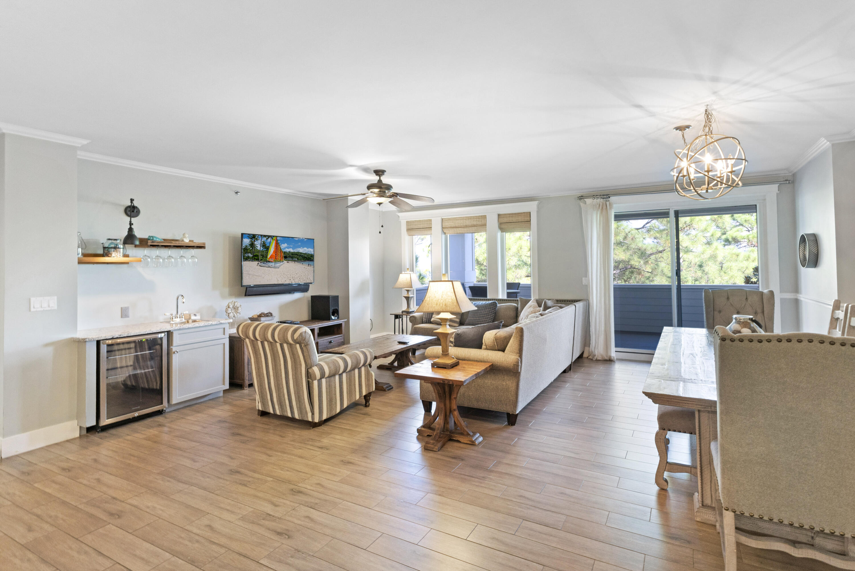 Perfectly positioned as a rare end-unit residence, this beautifully designed condo offers exceptional privacy with no adjoining neighbors on three sides. Enjoy panoramic bay views overlooking the Grand Lawn and resort-style pool, all best experienced from the oversized 300-square-foot covered balcony -- the perfect place to unwind and catch breathtaking sunset skies.
Inside, the thoughtfully designed split-bedroom layout features two spacious primary suites, each offering walk-in closets and private ensuite bathrooms for ultimate comfort and flexibility. The kitchen blends style and function with granite countertops, stainless steel appliances, and an oversized breakfast bar ideal for casual dining or gathering with guests.
The expansive living and dining area is made for entertaining, complete with a sophisticated wet bar and built-in beverage cooler. Elegant finishes throughout include porcelain plank tile flooring, crown molding, and a recently updated HVAC system installed in 2022, providing both style and peace of mind. As an introduction to the Sandestin lifestyle, we invite our new owners to explore amenities that make Sandestin special. The listing brokerage and seller(s) are presenting the buyer(s) of this property with (2) 90-minute rounds of Tennis court time, a golf foursome at one of our three championship courses, and a round of golf for up to four (4) players at the unrivaled Burnt Pine Golf Club.

Sandestin Golf and Beach Resort features more than seven miles of beaches and pristine bay front, four championship golf courses, 15 world-class tennis courts, a 226-slip marina, a fitness center, spa and celebrity chef dining. Shop, dine and play at the charming pedestrian village, The Village of Baytowne Wharf and more. Inside the gates of the resort, residents enjoy a balanced lifestyle of high-class living, spanning the 2,400 acres from the beach to the bay. Everything within the gates of the resort is accessible by golf cart or bicycle. The entire resort is interconnected by miles of pedestrian, bike and golf cart paths that weave through groves of live oaks, meandering past natural lagoons, fountains, man-made lakes, and meticulously landscaped fairways.