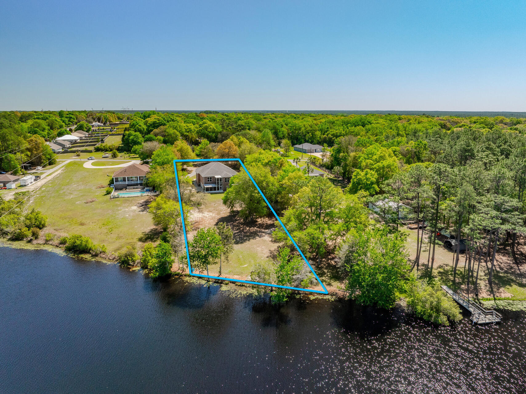 Experience Lakeside Luxury with this extraordinary Custom Built 4,508 sq. ft. One-Owner Lakefront Home in South Crestview, offering a serene retreat on 1.26 acres with 120 feet of frontage on a fully stocked 27-acre lake. There are several rooms that could be made into a 4th Bedroom!  Built in 2011 and meticulously maintained by its original owners, this unique property boasts exceptional features throughout.
Key Highlights:  Impressive Workshop: A 736 sq. ft. heated/cooled workshop with utility sink and rollup door, perfect for hobbies or storing a golf cart. An oversized 2-car garage and two spacious storage rooms complete the first level. Quality Construction: 2x6 framing, 9' ceilings throughout, 36' wide doors (except closets), and more than 450 sq. ft. of spray foam insulated attic space ensures energy efficiency. Modern Conveniences: Central vacuum system, Home Team in-the-wall pest control with termite bond, and two brand new HVAC systems (2022) for optimal comfort. Functional Main Level: Includes a spacious family room, well-appointed kitchen with wood cabinets, granite countertops, a dumbwaiter lift to the garage, large pantry, and breakfast bar. Adjacent sunroom leads to a screened porch, perfect for soaking in the lake views. A large laundry room with an island and an office add to the convenience. Primary Suite: Features a beautiful tray ceiling, expansive walk-in closet, and a thoughtfully designed en-suite bathroom with multiple vanities, Tiled Walk-In shower, and unique "drip-dry" closet with a drain for hand washables. Additional Living Space: There is a large Office next to the Primary Bedroom - Perfect for those who work from home. On the 2nd Level, there are also two guest bedrooms, a full bath, and a versatile parlor/bonus room. Carpeting is only found in the guest rooms, maintaining easy upkeep throughout. Extras: TVs are included, and a lawn tractor with a lift for maintenance is part of the sale. The property also features a storage shed and a scenic backyard leading to the water's edge. This is truly a one-of-a-kind property where you can enjoy peaceful lakefront living with modern amenities. Schedule your visit to fully appreciate the beauty and craftsmanship of this exceptional, One-Owner Home!