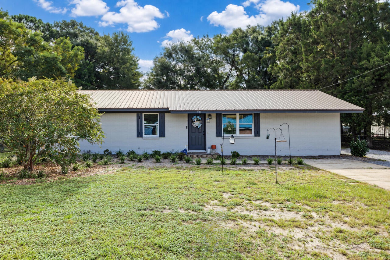 Welcome to 948 Lakeview Drive, a beautifully remodeled brick home in a popular area of DeFuniak Springs! Featuring a metal roof, newer HVAC, extensive updates, and beautiful sunset views of Back Lake, this move-in-ready home offers a great combination of location, updates, and outdoor space.

The home has been completely remodeled with new windows, fresh interior paint, new interior doors, LVP flooring throughout, kitchen and bathroom cabinets and countertops, light fixtures, blinds, and a new water heater. The updated bathroom features a new tub/shower and subway tile surround. The exterior brick and Hardie Board have also been freshly painted, and updated landscaping adds to the curb appeal.

The remodeled kitchen features new Frigidaire stainless steel appliances that convey, plenty of cabinetry, and a center island providing additional cabinet and countertop space as well as bar seating. The floor plan offers both a formal living room and a large den, providing valuable flex space for a second living area, home office, playroom, or whatever best fits your needs.

Outside, you'll find an outdoor storage shed and a large backyard with plenty of possibilities, whether you envision a garden, pool, outdoor entertaining space, or simply room to enjoy the outdoors. A separate agricultural meter is already in place for outdoor water use, with no sewer charges on ag-meter water consumption-a great feature for maintaining the yard, landscaping, or garden. The location is another highlight! Enjoy being close to Lake Stanley Park, offering swimming, fishing, a playground, picnic facilities, and a boat ramp. Wee Care Park is approximately 1 mile away and offers a splash pad, playground equipment, walking trail, baseball/softball and soccer fields, basketball and tennis courts, batting cages, pavilions, and more. The home is also conveniently located near area schools and just 3 miles from Downtown DeFuniak Springs, putting local shopping, dining, and everything MainStreet has to offer within easy reach.

With its extensive remodel, metal roof, newer HVAC, spacious backyard, Back Lake sunset views, and convenient location, 948 Lakeview Drive is ready to welcome its next owner!