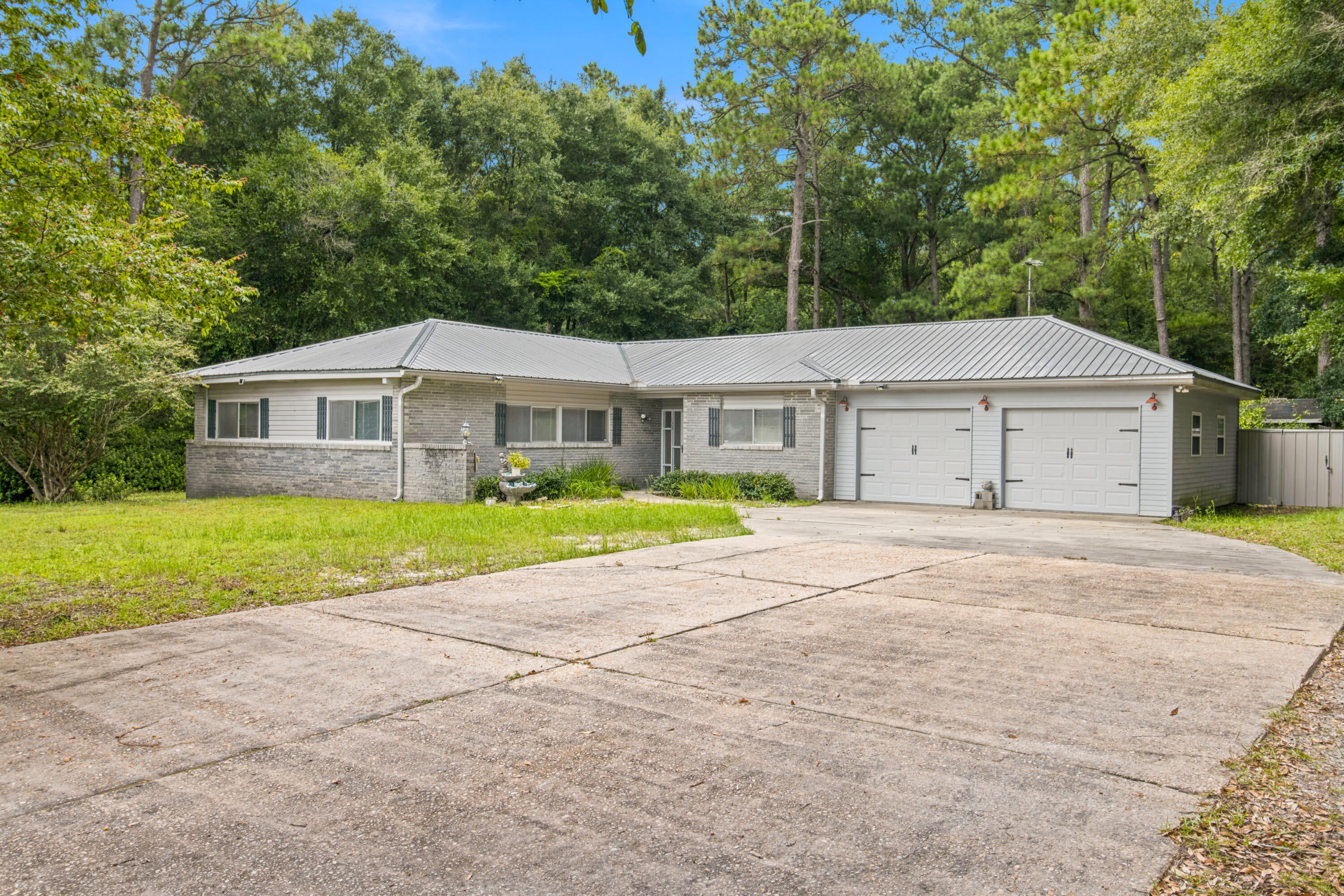 Just outside the city limits of DeFuniak Springs, this ranch-style home sits on just over an acre, offering the extra space you've been looking for while still being only minutes from shopping, dining, schools, and everyday conveniences.Inside, you'll find a formal living room along with a separate family room tucked away near the front of the home, making it the perfect space for a home office, playroom, or sitting room. The laundry room connects directly to the attached garage, adding extra convenience to your everyday routine.
Step out onto the back deck and enjoy your morning coffee or relax in the evening while taking in the peaceful surroundings. With over an acre to enjoy and a location just a short drive from shopping, dining, and everyday conveniences, this home gives you the feel of country living while keeping you close to everything you need.
Buyer to verify all dimension and lot size.