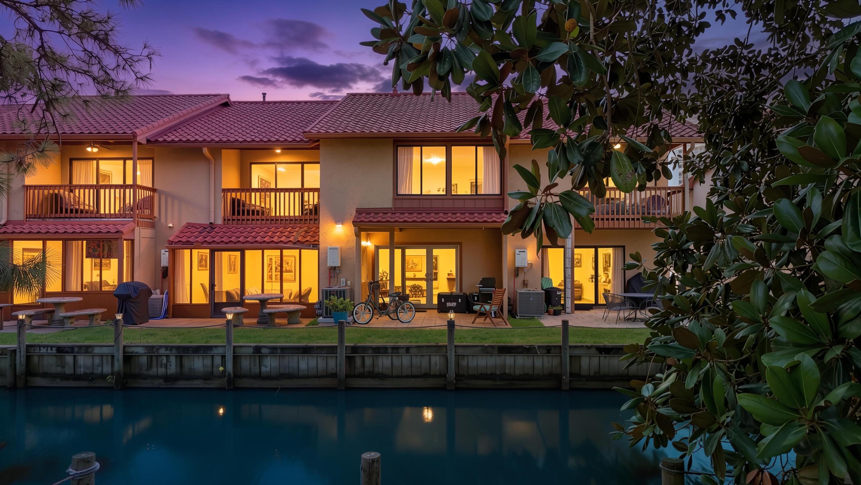 This is why everyone wants an Island unit. Waterfront, 1,500 sq ft, just a 2-minute walk to the beach, and a brand-new metal roof installed this year. Come see why! Welcome to this beautifully maintained waterfront townhome, perfectly positioned directly across from the community's largest pool and just a short stroll to the sugar-white sand. Used primarily as a second home and now a full-time residence, this property has been well cared for and is move-in ready. Enjoy peace of mind with a brand-new metal roof installed this year, a $20,000 improvement. Inside, you'll find a beautifully updated kitchen featuring quartz countertops, solid wood cabinetry, an accent backsplash, and an open-concept layout that's perfect for entertaining or relaxing after a day at the beach. Step outside to your back patio and take in the peaceful canal views, beautiful sunsets, and the sounds of nature while grilling fresh Florida seafood. It's the perfect setting to unwind after a day in the sun. Island units are the largest and newest townhomes in the community, offering approximately 1,500 square feet of living space with an open floor plan that feels more like a home than a typical beach condo. Offered furnished and rental-ready, this property is ideal as a primary residence, vacation home, or investment property. Additional highlights include two assigned parking spaces directly in front of the unit, VA and FHA financing eligibility, and an unbeatable location just steps from the largest  pool and only a 2-minute walk to the beach. If you've been waiting for a waterfront Island unit, this is one you won't want to miss. Schedule your private showing today. LOW HOA fees include: 11 pools(5 heated), pickleball, shuffleboards, gulf-front restaurant & pool, mini golf, exercise room, tennis courts, playground, WIFI, pest control, termite bond, trash, ground keeping, property patrol, gated community and more.