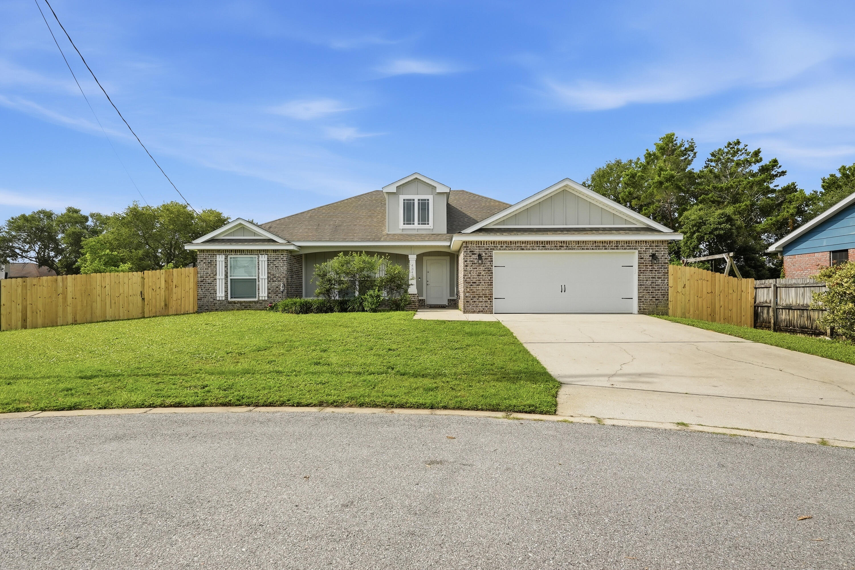 Beautifully maintained Craftsman-style brick home tucked away on a cul-de-sac lot in desirable Gulf Breeze. This 1,717 sq ft open floor plan features a spacious great room with trey ceiling and recessed lighting, flowing into a beautifully appointed kitchen with granite countertops, under mount sink with pull-down kitchen faucet, tile backsplash, painted cabinetry with soft-close drawers, stainless steel appliances, and 30'' upper cabinets. Durable 18''x18'' tile flooring runs throughout the kitchen, breakfast area, foyer, bathrooms, and utility room. Designed with comfort in mind, the home includes insulated interior walls between bedrooms/bathrooms and living areas for added sound reduction. The primary suite offers a tray ceiling and a spa-like bath featuring double granite vanities, garden tub with tile surround, full tile shower with seamless glass door, and a walk-in closet. Outdoor features include a 23'x7' covered back porch, custom brick-built grill station, irrigation system with well and fenced backyard. **Recent upgrades include plantation shutters in the living and dining areas, a custom brick-built grill station (2025), new lawn pump (2025), newer stove, dishwasher, and microwave replaced within the past 3 years, new carpet, and professionally cleaned HVAC ducts.**