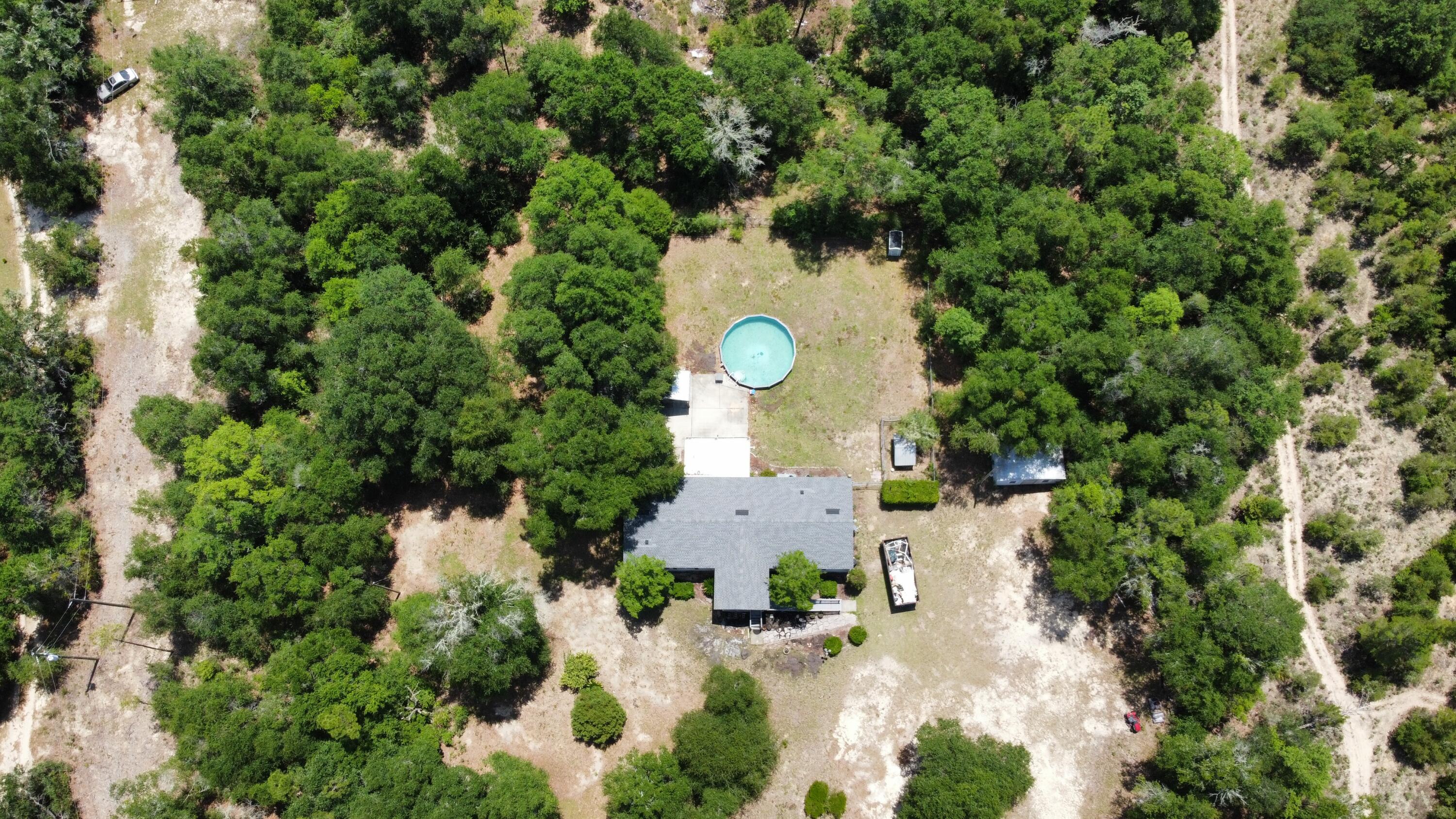 Spacious 3/2 home  with a pool on 5 acres close to major highway stores and beaches 40minutes to panama city ,Spacious master bed room master bathroom ,walk in closet 2097 total 1809 living 2 sheds 
Best of both worlds