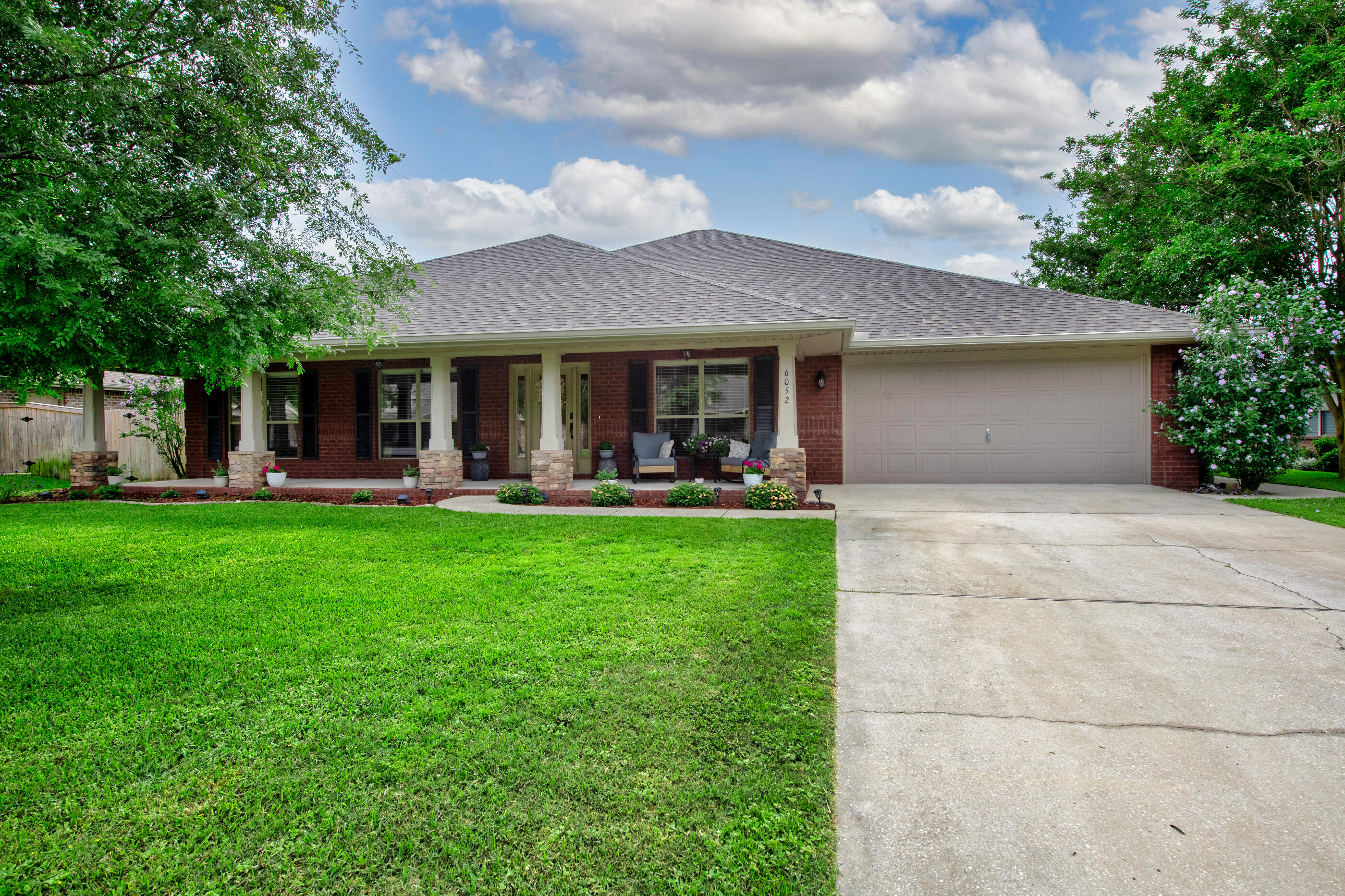 Spacious, versatile, & packed with upgrades, this 3,137 SF home in the desirable Midway area of Gulf Breeze has room for everyone! Featuring 4 bedrooms, 3 bathrooms, & a large bonus room, this home is also zoned for the new Soundside High School. The oversized kitchen is truly the heart of the home, complete with granite countertops, a large island with built-in wine rack, attached breakfast nook, & a huge pantry with convenient light sensors. The living room offers a cozy stone-accented wood-burning fireplace & opens directly to one of two covered patios, making indoor/outdoor entertaining a breeze. The spacious primary suite features a trey ceiling, sitting area, & an ensuite bath with double vanity & granite countertops, garden tub, separate shower, & two oversized closets. Need extra flexibility? The formal dining room can easily serve as a flex space, while the bonus room is perfect for a home office, game room, media room, or even a future 5th bedroom. Additional highlights include surround sound wiring throughout the entire home plus major updates already completed: Roof & HVAC replaced in 2026, new carpet in bedrooms & bonus room in 2024, tile flooring in 2023, wood-look LVP in 2021, & water heater replaced in 2018. This home offers the perfect combination of space, function, & comfort in a fantastic Gulf Breeze location!