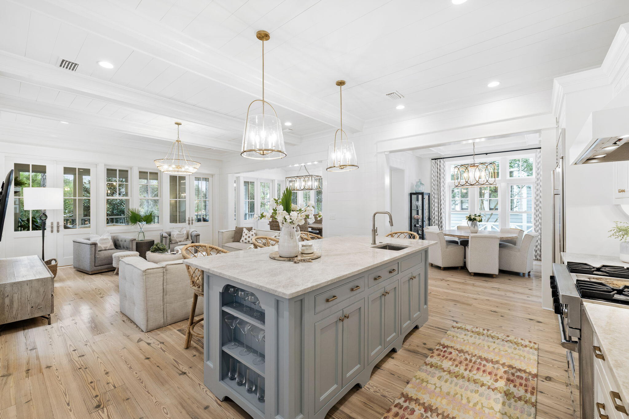 Featuring a beautifully renovated kitchen, this T.S Adams designed 5-bedroom, 5-bath coastal cottage retreat overlooks peaceful Yacht Pond in the exclusive gated, Gulf-front community of Watersound Beach.
Designed for effortless coastal living, the home offers an open and inviting floorplan with abundant natural light, high ceilings and thoughtfully designed spaces that flow seamlessly from kitchen to living areas and outdoor gathering spaces. Designer furnishings and custom décor complement modern conveniences including smart home automation for lighting, climate control, leak detection, and security.
At the heart of the home is the newly renovated main level kitchen, featuring a large island with Taj Mahal quartzite countertops, professionally painted cabinetry, elegant gold hardware , modern fixtures, premium appliances and deep basin sinks. Beautiful statement lighting and bar seating make this space ideal for entertaining, while two dining areas provide flexible options for family meals and gatherings.
The living spaces open effortlessly to a new screened porch retreat, complete with a cozy seating area, bed swing, gas lanterns, and fireplace. Just beyond, a new custom fence encloses the private backyard, featuring a patio with charming bistro lighting and a gate providing direct access to Yacht Pond and Watersound's scenic walking trails.
Above the two-car garage, a private carriage house suite offers comfortable accommodations for guests or extended family with a bedroom, full bath, living area, eat-in kitchenette, and private balcony. A nearby grill patio conveniently sits between the carriage house and main home.
The main house includes four additional bedrooms, including a main-level guest suite and a charming built-in bunk room. The primary suite provides a spa-like retreat with a Juliet balcony, dual vanities, soaking vessel tub, and separate walk-in shower.
Upstairs, a secondary living and TV area offers additional gathering space, while a spiral staircase leads to a private office and sunlit tower room with kitchenette and Gulf views.
Located within the main gate of Watersound Beach, residents enjoy access to a private beach, scenic dune walkovers, coastal dune lake access, resort-style pools, dog parks, playground, dedicated post office, "Puttering Park", boardwalks, and miles of scenic walking and biking trails along one of the most beautiful stretches of 30A.