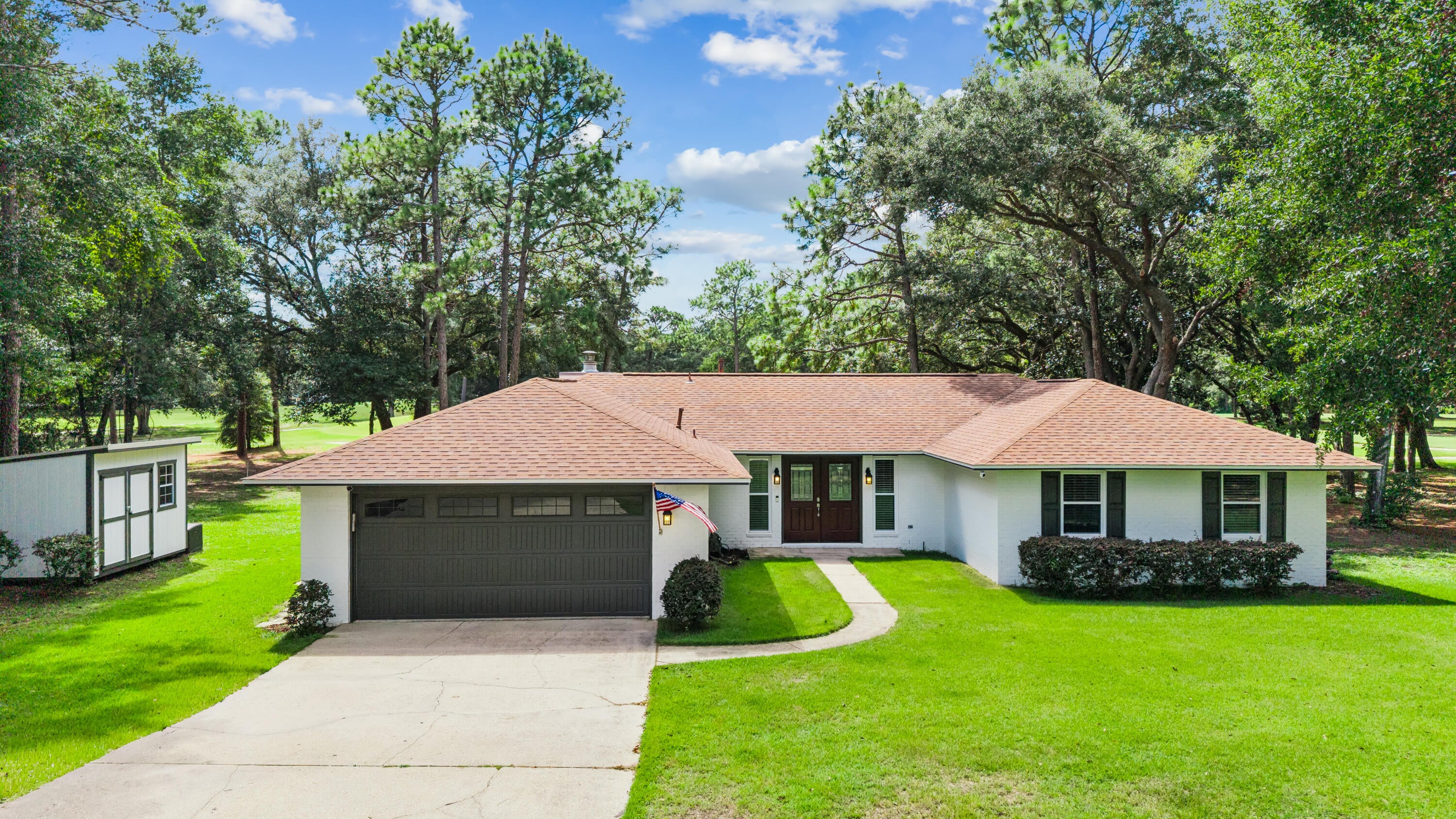 Immaculate and move-in ready, 1101 Forest Rd presents a rare opportunity for quintessential country club living on a grand scale. This 3BR/2BA, 1,861 sq ft residence sits on a sprawling 0.52-acre lot positioned directly between the 7th green and 8th tee box of Rocky Bayou Country Club, ensuring spectacular views of the course from every angle.
The home's interior features immediate updates and a high-end feel throughout. The main living area showcases stunning real bamboo flooring and is anchored by a floor-to-ceiling whitewashed rock natural gas fireplace flanked by massive windows. The renovated kitchen boasts gorgeous polished granite countertops, warm natural wood cabinetry, a decorative backsplash, and a modern farmhouse sink with a sleek stainless steel pulldown faucet, plus a complete set of stainless steel gas appliances.

The efficiency continues throughout the home with full natural gas infrastructure, including a gas furnace and gas hot water heater. The master bathroom offers an updated retreat featuring a modern walk-in shower with tile surrounds.

Outside, the lifestyle opportunity is unmatched. Relax on the deep, expansive screened-in back porch equipped with multiple ceiling fans--the perfect venue for entertaining while overlooking the fairways. The property also features a detached workshop or storage shed with a roll-up door. Zoned for top-rated Niceville schools and moments from bay access and Eglin AFB. Don't miss this complete package!