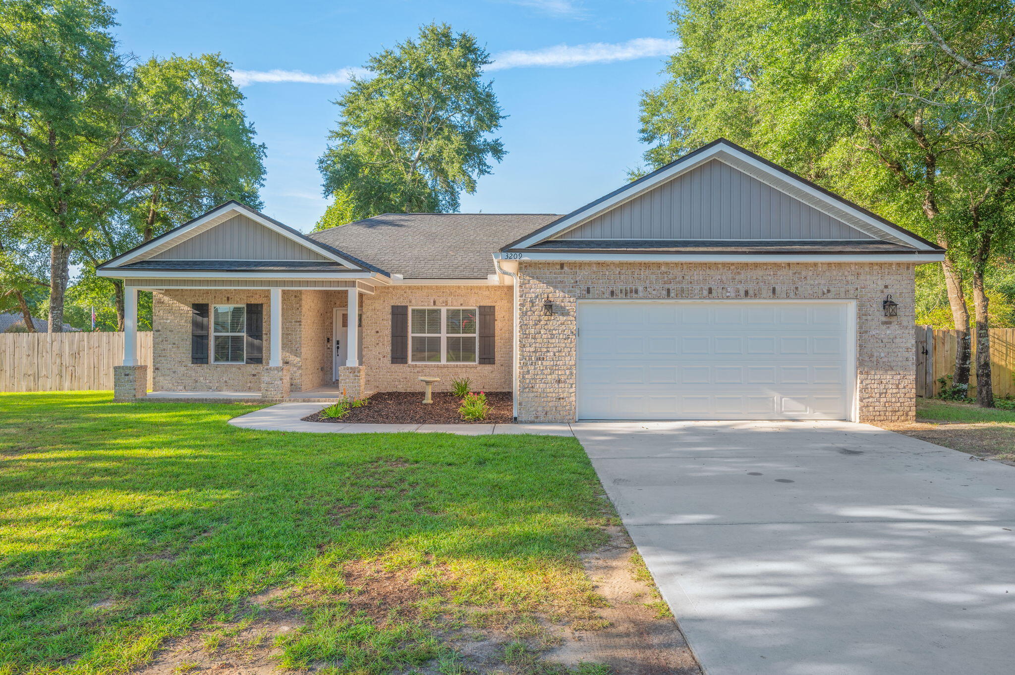 Welcome to 3209 Twilight Drive! This stunning 4-bedroom, 2-bath home is nestled on a spacious corner lot surrounded by mature oak trees and features a beautiful all-brick exterior with a charming Southern-style front porch. Step inside to vaulted ceilings, an inviting open-concept floor plan, and luxury vinyl plank flooring throughout. Thoughtfully upgraded trim and designer lighting add an elevated touch to every space. At the heart of the home is the beautifully designed kitchen, featuring custom white shaker-style cabinetry, stainless steel appliances, and a generously sized granite island that provides plenty of workspace and gathering space. The spacious living room flows seamlessly from the kitchen, creating the perfect setting for everyday living and entertaining. The split-bedroom floor plan offers privacy and functionality, with a spacious primary suite designed to accommodate oversized furnishings. The ensuite bath features dual vanities, a luxurious freestanding soaking tub, and a custom-tiled shower. All additional bedrooms are generously sized, providing plenty of room for family, guests, or a home office. Outside, enjoy a beautiful, private backyard enclosed by a privacy fence--perfect for relaxing or entertaining. With it's charming Southern curb appeal, thoughtful upgrades, spacious layout and beautiful lot, 3209 Twilight Drive is a home you won't want to miss! LISTING AGENT IS RELATED TO OWNER.