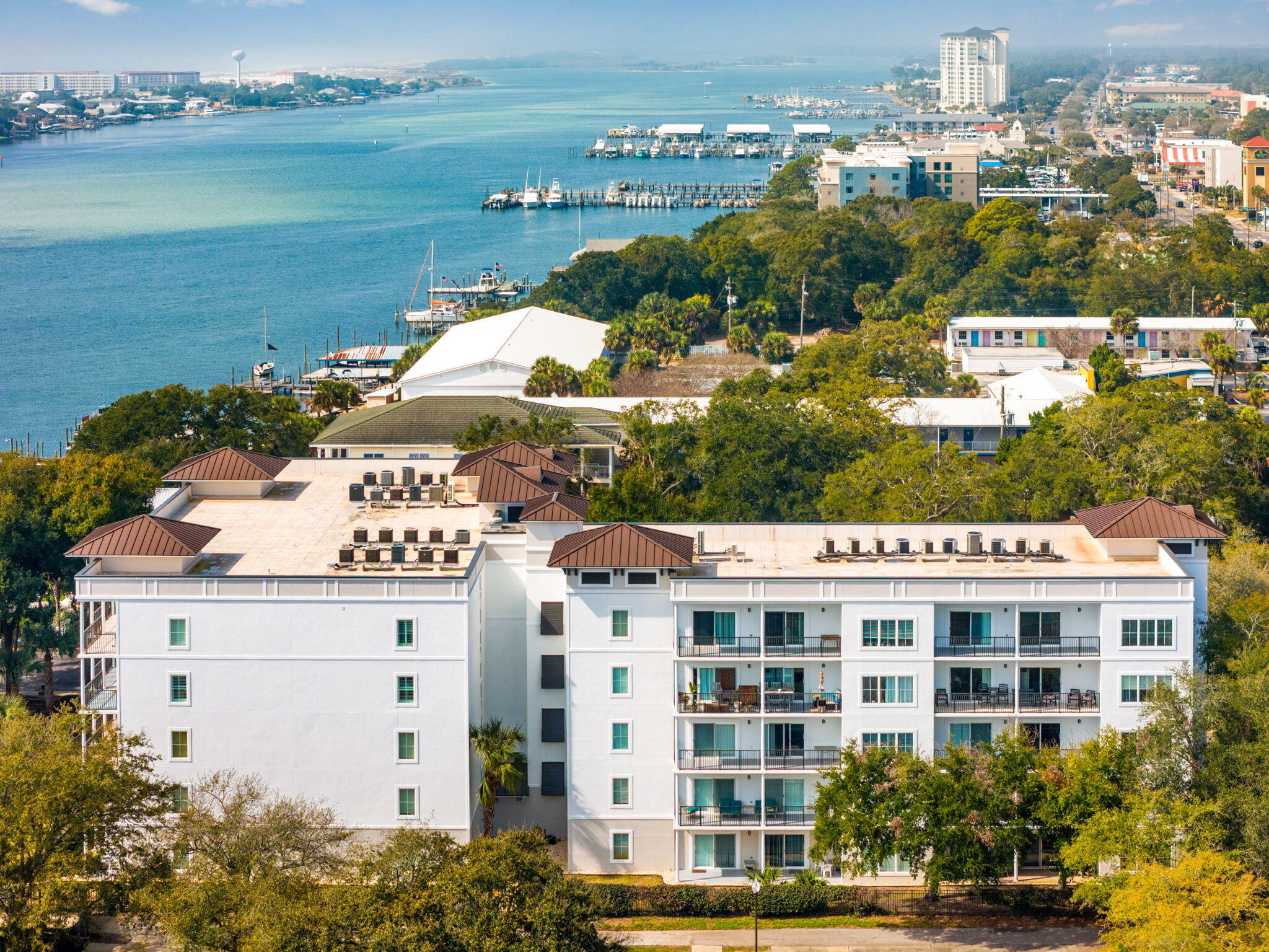 VA APPROVED. Welcome to this premier waterview residence in the gated Indianola on the Water community. This spacious condominium offers over 1,800 square feet of thoughtfully designed living space with tranquil water views. The open floor plan features 9-ft ceilings, tile flooring in the main living areas, and expansive windows that flood the home with natural light - ideal for everyday living or entertaining. As an end unit, you'll enjoy additional privacy and a quiet, elevated setting. The living area and primary suite open to a private balcony overlooking the water, perfect for morning coffee or evening relaxation. Each bedroom includes an en-suite bath, providing comfort and privacy for family and guests. Private storage adds valuable functionality rarely found in condominium living. The community enhances your lifestyle with a sparkling pool, gated entry, elevator access, and beautifully maintained grounds; steps from the vibrant Fort Walton Beach Landing, local restaurants and parks. You will be just a short drive to the beautiful beaches of the Emerald Coast and both Eglin AFB and Hurlburt Field. Schedule your showing today!