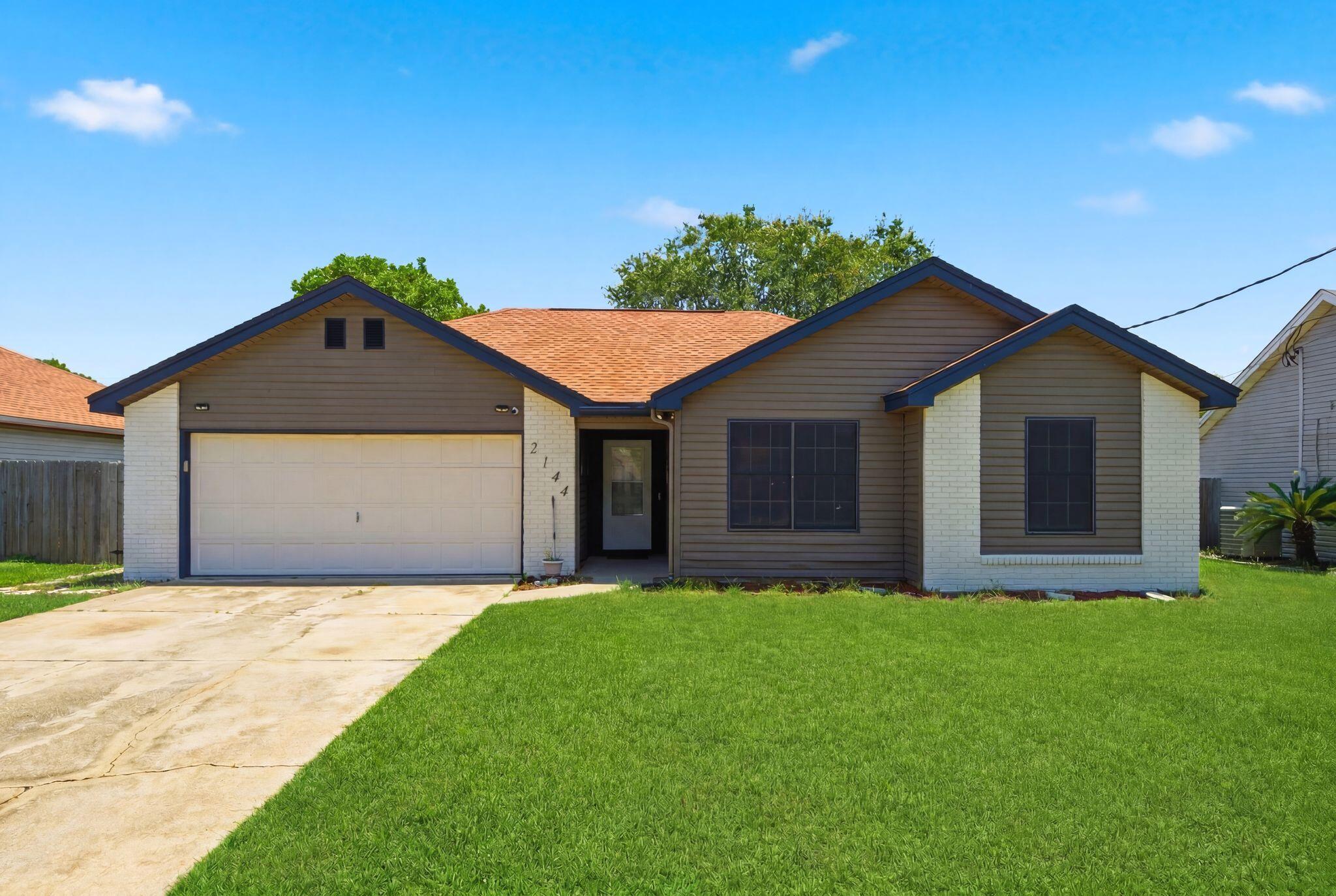 Don't miss this inviting 3-bedroom, 2-bath home at 2144 Estates Circle. The home features an open living and dining area with vaulted ceilings, a remodeled kitchen with quartz counters and stainless steel appliances, and a spacious master suite with a walk-in closet and private bath. Outside, enjoy morning coffee on the covered patio overlooking a fenced backyard ideal for pets and outdoor gatherings. Two-car garage and extra driveway parking provide convenience for guests. Perfect for families, retirees, or vacationers seeking easy access to Navarre's beaches, shopping, and dining. Schedule your showing today!