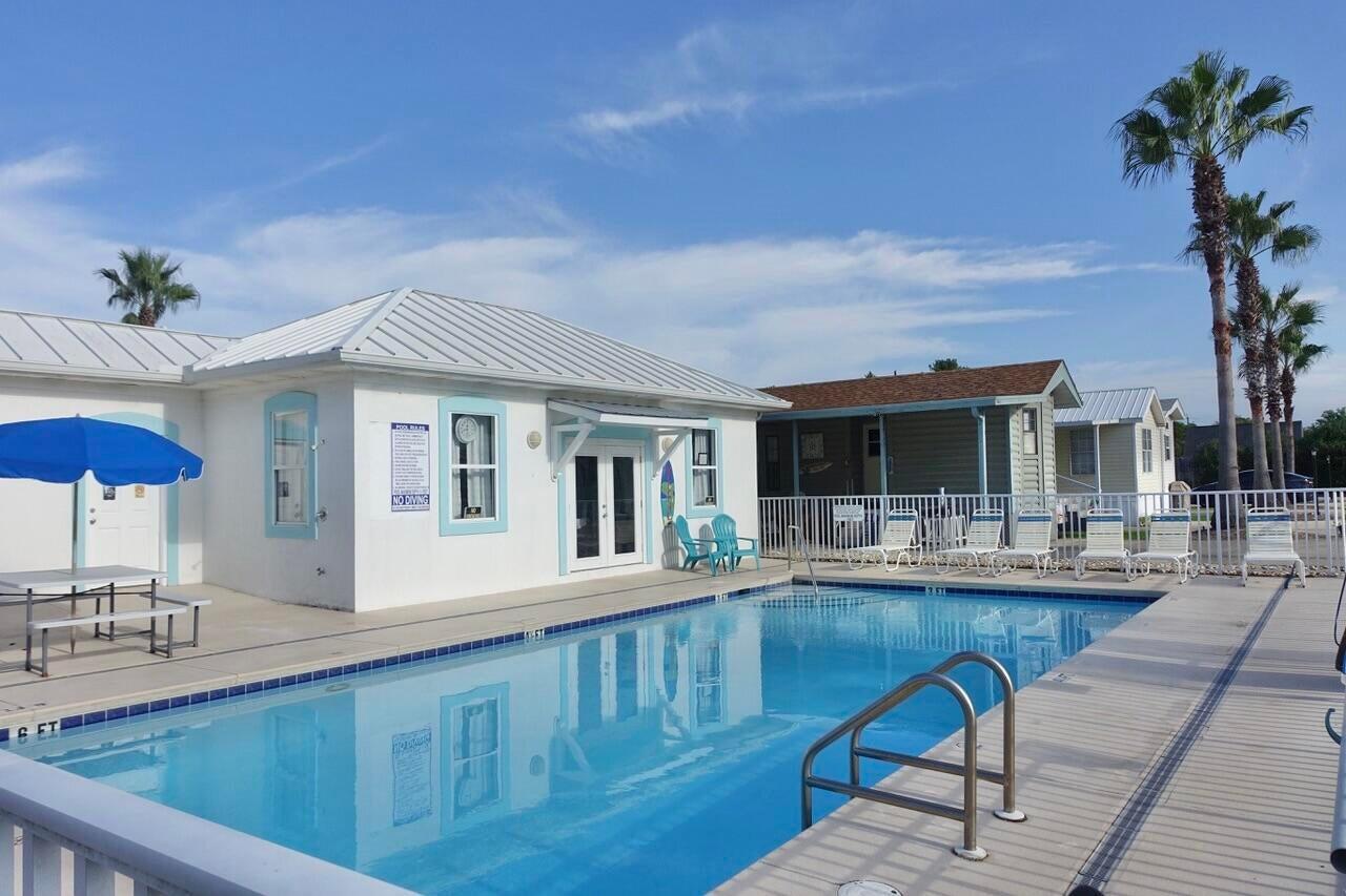 An incredible opportunity to own property just one block from some of Florida's most beautiful Beaches at an unbeatable price. Located within a Gated Community, this 2-bedroom, 1-bathroom park model offers both comfort & convenience, along with access to a Community Pool. Whether you're looking for a primary residence, vacation getaway, or investment property, this home fits the bill. The community allows a mix of full-time residents & rentals, with strong income potential & favorable returns. Ideally situated near the Community Pool, the property also features a desirable east-facing front--perfect for enjoying morning light. Two dedicated parking spaces are included for added convenience. Beach access is easy, with 3 public parking lots within two blocks. The nearby Public Beach offers restrooms and is home to the popular Pompano Joe's Beachfront Restaurant, Bike/Pedestrian Path & Manmade Reef. Opportunities like this don't come around often--don't miss your chance to own a slice of Paradise near the Gulf of America. Property is offered furnished excluding Owners personal items. Storage House has Washer/Dryer & Shelves.