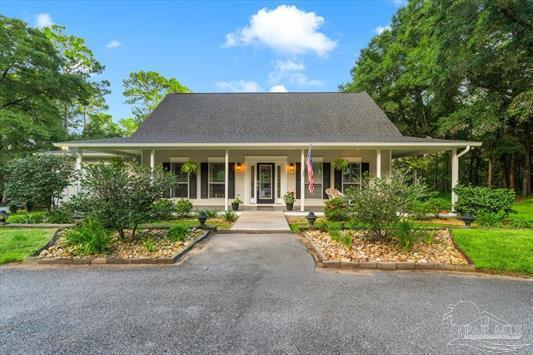 A hidden gem where timeless Southern charm meets a private coastal region retreat, this extraordinary park like 8-acre estate offers a rare combination of space, natural beauty, and resort-style living. Balanced forest, open spaces and mature trees, this 4-bedroom, 2.5-bath home offers approximately 3,202 sf of living space plus a 379-sf versatile basement space and detached 2 car shop. Located in beautiful Milton, FL. From the moment you arrive, the winding drive, established grounds, and welcoming covered porches set the tone. Inside, beautiful natural light fills the home, creating a warm and inviting atmosphere. The chef's kitchen serves as the heart of the home, while two living areas provide exceptional space for entertaining and everyday living. The primary suite is conveniently located downstairs, offering a peaceful retreat complete with a beautifully oversized bathroom and enormous walk-in closet. Upstairs, additional bedrooms provide plenty of space for family, guests, or a home office. Step back outside and discover your own private resort. A screened-in porch, open spaces, rolling lawn, the sparkling pool. A brand-new cabana added in 2025 creates the perfect poolside entertaining area.  New pool liner, pool pump and filter, and Polaris pump. Beyond the pool, the property becomes a true nature lover's paradise. Rolling open acreage, mature woods and trails, and a natural fish nursery in the spring-fed creek create an incredible backdrop filled with deer, turtles, and abundant birdlife. Whether you're swimming, entertaining, exploring the acreage, or simply enjoying the peaceful surroundings, this property offers an extraordinary lifestyle. A few recent improvements include a 2025 HVAC system and a 2022 roof. Private, peaceful, and beautifully appointed--this is more than a home. It's your own private oasis.