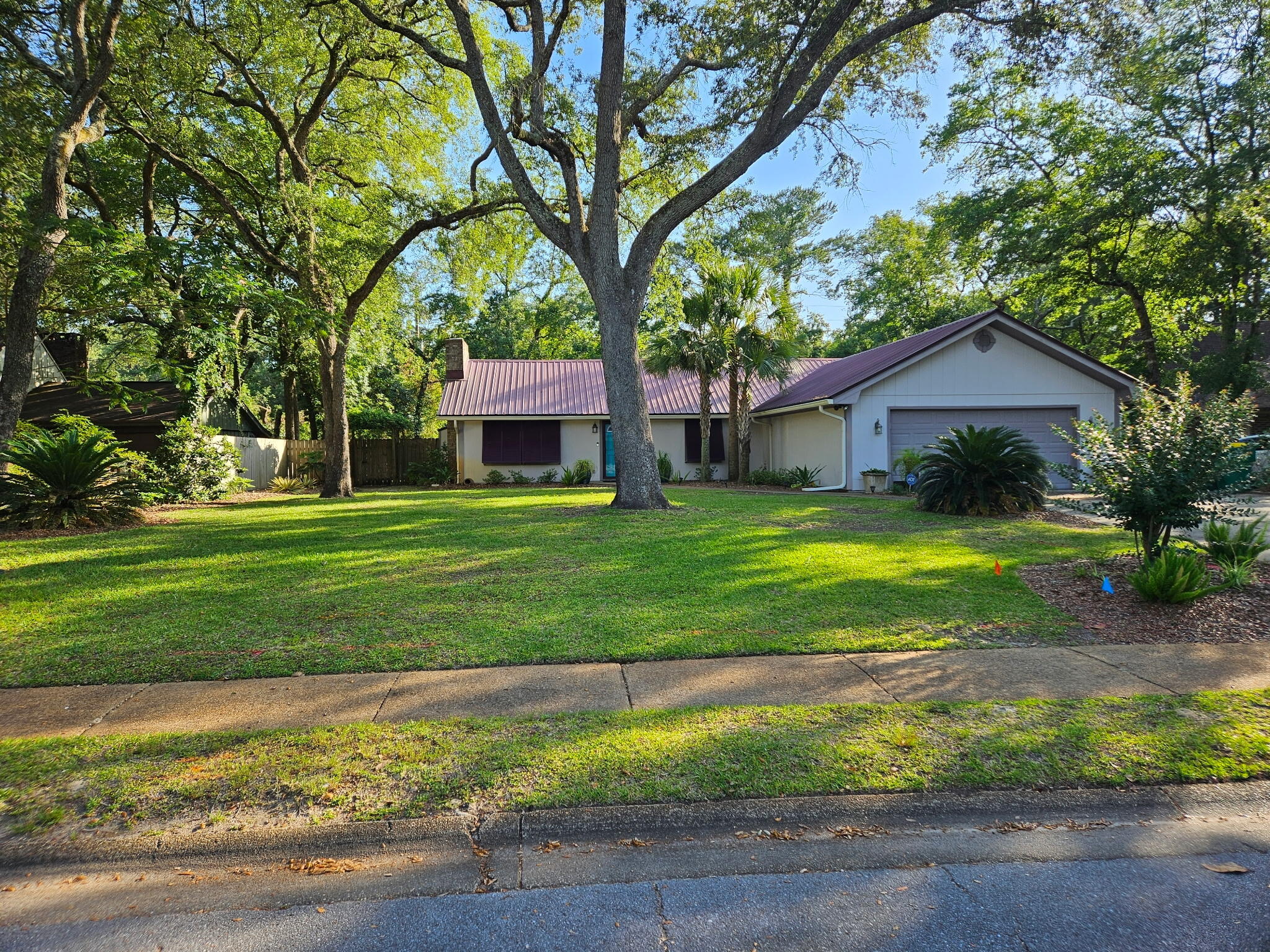 Beautifully maintained home featuring solar panels (Paid off at closing) A.C only 3 years old, a stunning pool, lush tropical landscaping, metal roof, and a modern gas fireplace. The spacious backyard creates a private oasis perfect for entertaining or relaxing. Conveniently located in the heart of Niceville near schools, shopping, dining, and local amenities. Enjoy comfort, style, and Florida living at its best. Move in ready! The large tile entry flows  to the living room, kitchen, dining room and spacious bedrooms. Off the kitchen is a formal dining room with space for a large table and hutch. Upgraded windows and doors, irrigation system, large rear covered patio area, Open cell foam insulation in attic including above garage, On demand Renai gas water heater.. and so many other extras you must see!  Buyer to verify dimensions.