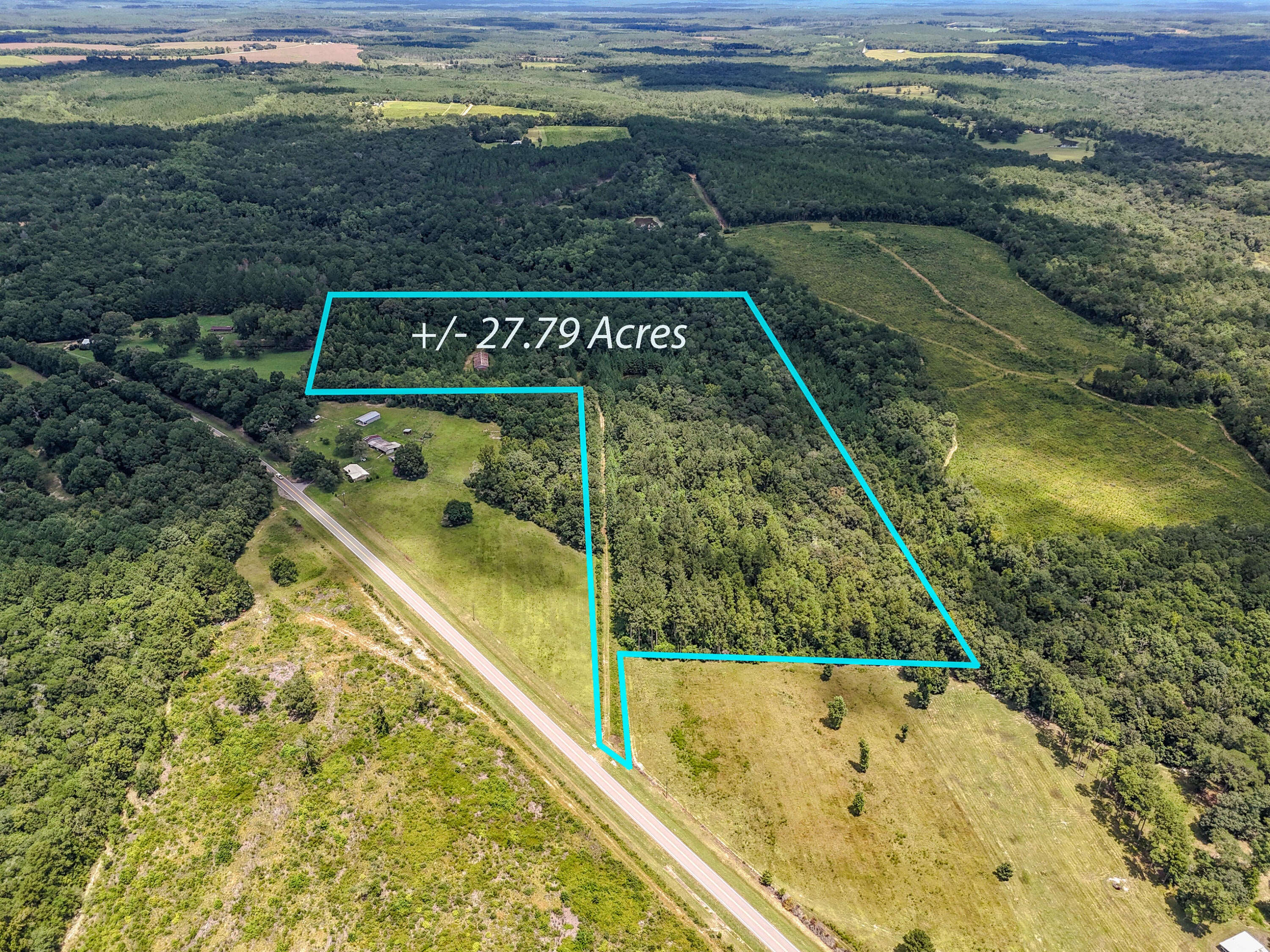 Been looking for the perfect piece of acreage? This is it. Located in the North part of Walton County on a paved road this acreage first welcomes you with a long private drive into your land. This is a rare opportunity of finding such a beautiful 27.79 acres of natural Florida land, complete with an amazing peaceful pond, mature hardwoods, and the kind of privacy that's hard to find. This perfect size tract of land offers untouched landscape and valuable improvements, creating the perfect place you have been dreaming of! Electric service is already in place, allowing you power immediately without the worry of the cost to get it to the property. A large metal barn sits on top of the hill that is perfect for equipment and farm storage, a workshop, hunting accessories storage or any needs you need out of a barn. The land offers rolling wooded terrain that provides stunning views, abundant wildlife, and endless opportunities for trails, hunting, or simply enjoying the quiet. Perfectly positioned for convenience, this property is a short drive back in to town for shopping, less than 40 minutes to the beaches, along with easy commutes to numerous arears of work through the country backroads offering both seclusion and access to the best the area has to offer. Whether you are looking for your final place to make your home, a weekend getaway, or a property to pass down for generations, this acreage offers unmatched potential and timeless beauty only found in North Walton County.