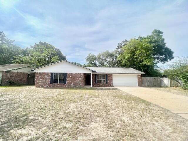 This beautiful all brick home is centrally located between Eglin Air Force Base and Destin. It features 4 bedrooms and 2 bathrooms, two living areas, one at the front of the house and one at the rear of the house.  The front living room can double as a workspace! Kitchen features granite counters, stainless-steel microwave! Kitchen door leads to the side privacy fenced yard. Primary bedroom features en-suite with Walk in closet. **Fireplace not functional**