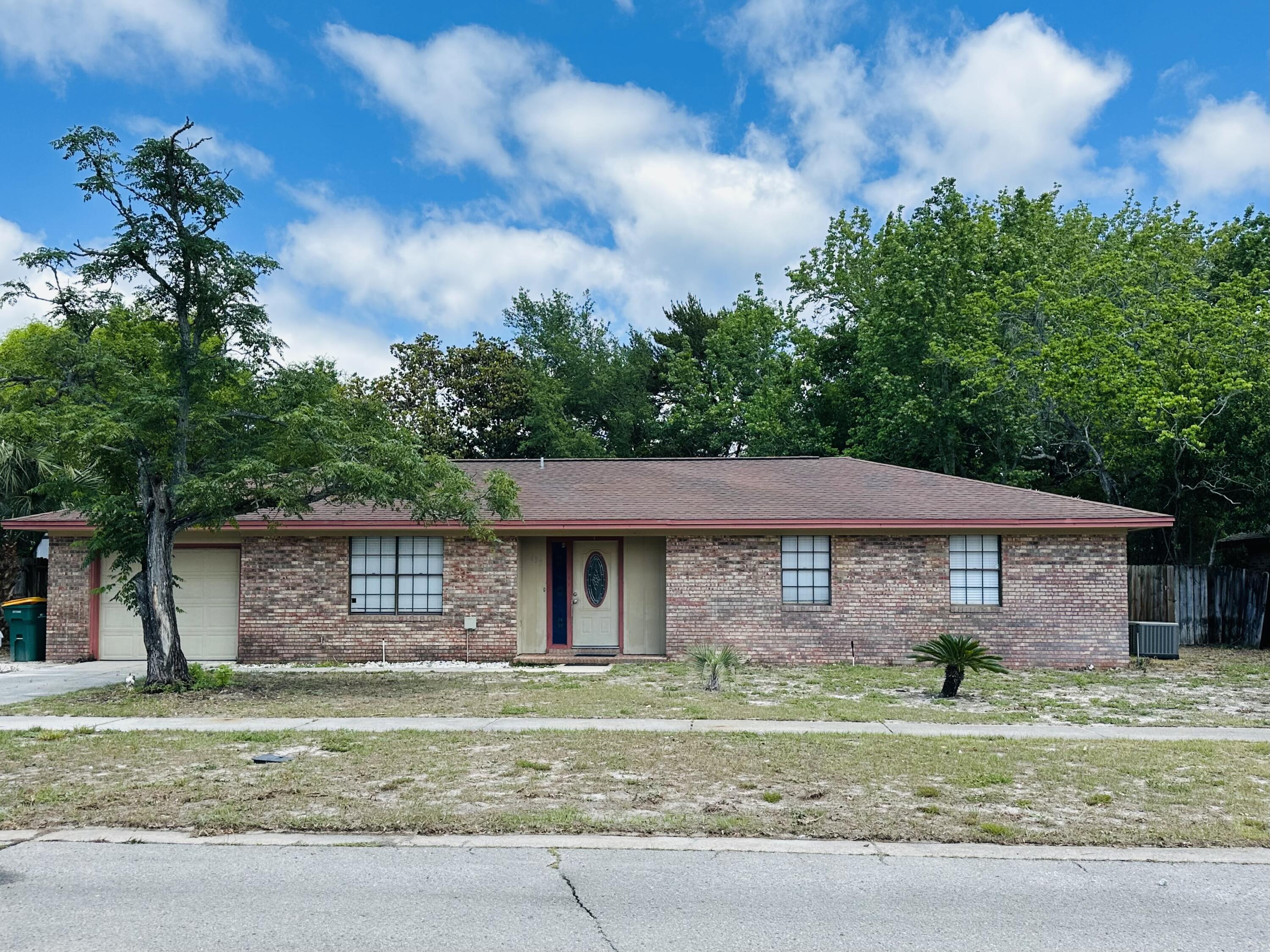 NEW PRICING! Located in the heart of Destin on Sea View Dr. (also known as Christmas Tree Street), this property is within walking distance of Destin Harbor, restaurants, and a park with tennis courts. The home features 3 bedrooms, 2 baths, an office, and a garage. The AC was replaced in 2023. The property has a large, fenced backyard. Seller will offer Roof replacement at closing with acceptable offer.  It is being sold 'as is' with the right to inspect and needs a little TLC. Imagine the impact of a fresh coat of paint and updating the shower with a neutral color. Conventional financing is recommended. (not VA)