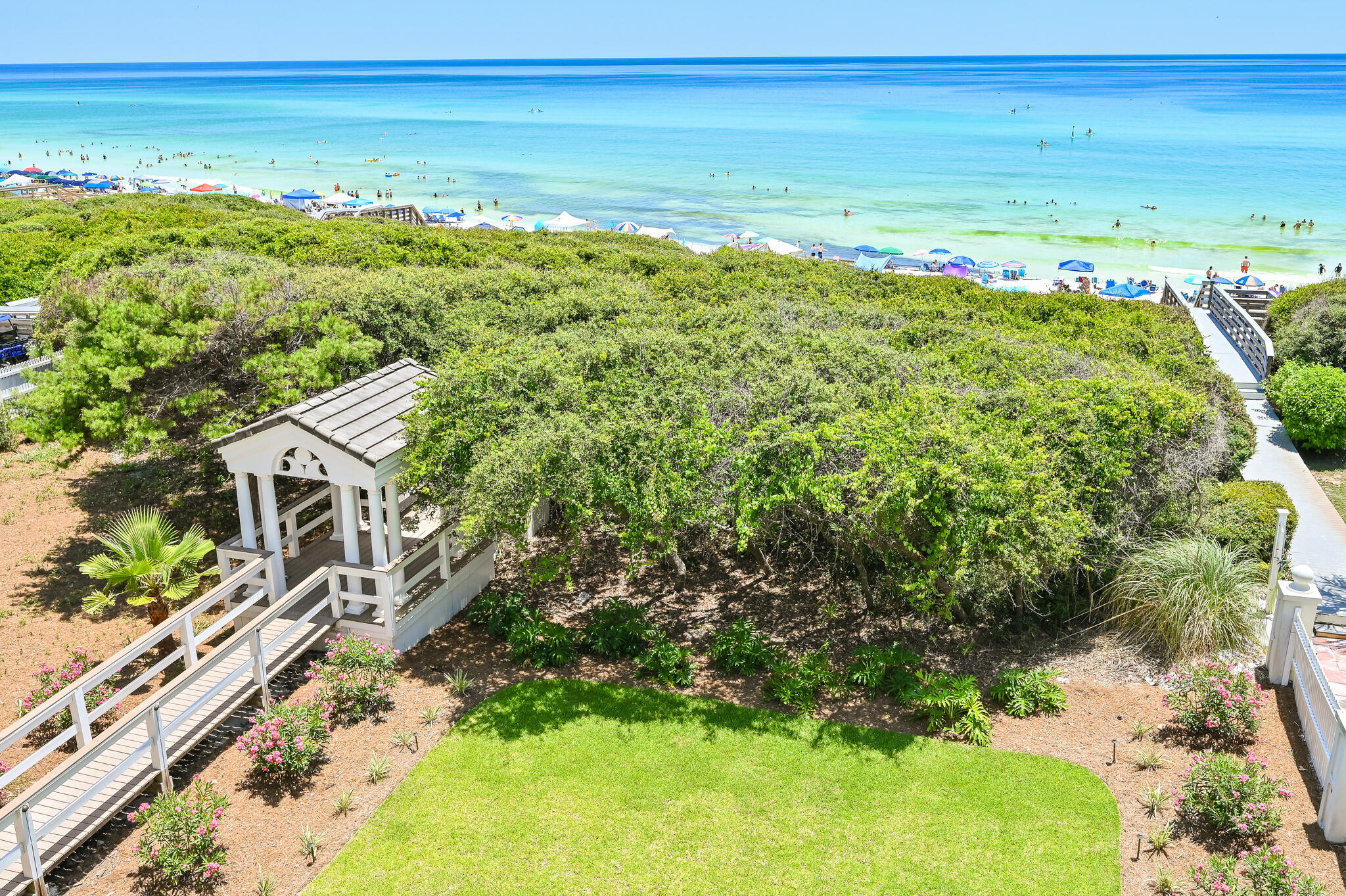 Discover coastal luxury at its finest with this stunning gulf-front Seagrove Beach Cottage, located at 36 S San Juan Avenue, Santa Rosa Beach, FL 32459. This exquisite 4-bedroom, 3-bathroom home spans 3 floors with 57 feet of breathtaking beach frontage, offering direct access to a serene, uncrowded beach via a private boardwalk through a secluded tree arbor atop a high dune.
