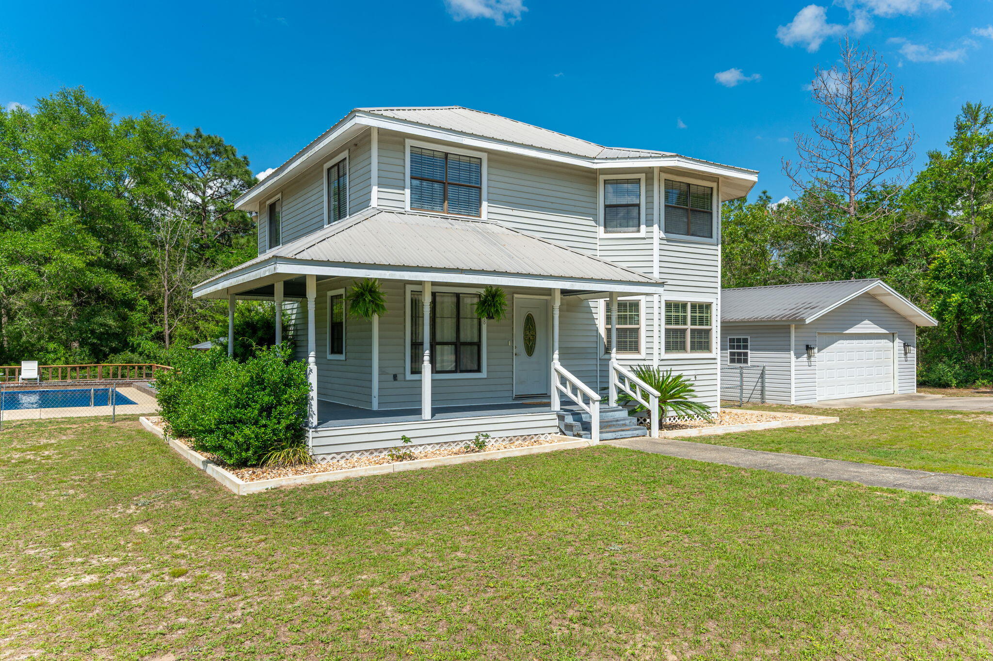 Step into the perfect blend of comfort, style, and Southern charm with this spacious 2 story home loaded with upgrades and outdoor amenities! Featuring 4 bedrooms, including 2 private ensuites  and 3.5 bathrooms, this home offers the ideal setup for multi generational living, guests, or simply spreading out in style.
The downstairs received a beautiful refresh in 2023, including renovations to the kitchen, office, laundry room, and downstairs ensuite. The updated kitchen shines with gorgeous granite countertops, while the renovated ensuite  features a sleek tile walk-in shower that feels straight out of a spa retreat & private access to an outside deck. Outside is where this property truly steals the show! Spend your summers lounging beside the sparkling 16x30 inground saltwater pool, hosting gatherings under the pavilion, or enjoying the privacy of the fenced backyard. The circle driveway adds curb appeal and convenience, while the 24x24 detached 2-car garage and additional detached carport provide plenty of room for vehicles, boats, toys, or hobbies. Topped off with a durable metal roof and low maintenance vinyl siding, this home checks all the boxes for comfortable living and entertaining! Call your favorite Real Estate Agent to view this gorgeous property in person.