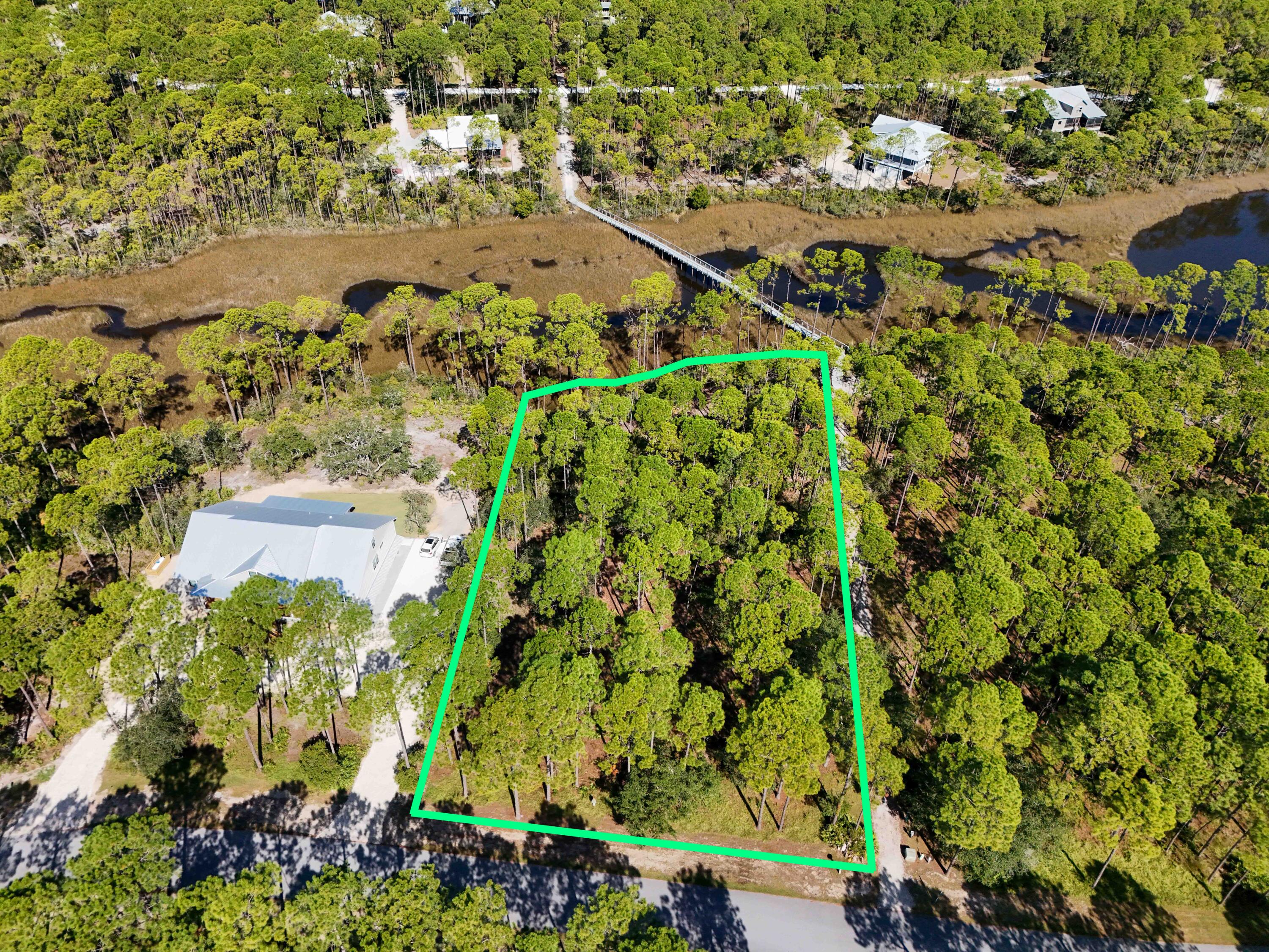 Discover the perfect place to build your dream home on Lot 114, a beautiful 0.95+/- acre wooded homesite in the highly sought-after RiverCamps on Crooked Creek. Surrounded by nature, this private lot offers a peaceful setting with stunning natural views while remaining just minutes from the sugar-white beaches of the Emerald Coast, premier shopping, dining, and Northwest Florida Beaches International Airport.

RiverCamps is a gated, nature-focused waterfront community designed for those who love the outdoors. Residents enjoy exceptional amenities including a community boat ramp, day-use boat slips, fishing, paddleboarding, kayaking, scenic walking trails, and access to Crooked Creek, West Bay, the Intracoastal Waterway, and the Gulf of Mexico. Whether you're an avid angler, boater, or simply enjoy the beauty of Florida's natural landscapes, RiverCamps offers an unmatched lifestyle.

With abundant wildlife, mature trees, and nearly an acre of privacy, this homesite provides the perfect opportunity to create your custom retreat in one of Northwest Florida's most unique waterfront communities. Don't miss your chance to own a piece of paradise where nature, recreation, and convenience come together.