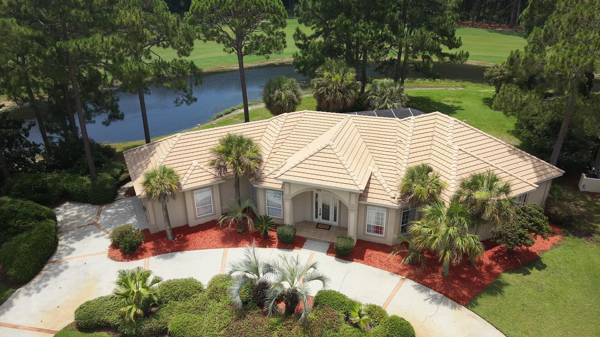 Custom-built home situated in the sought-after location in the gated community of Emerald Bay. Private corner lot with no neighbors to the left on one of the largest lots located in Emerald Bay. Sold 'Furnished'.  Spacious great room with trayed ceiling opens to the screened lanai with heated pool overlooking lake and the 6th fairway. The view is incredible. This home is nicely  landscaped with circular driveway, landscape lighting, high impact windows, outdoor stainless steel natural gas grill, outdoor shower, and oversized side-entry garage with extra storage room. Interior features include: zoned heating and cooling, upgraded lighting, open spacious floor plan with crown molding throughout; 18'' porcelain floor tile; 8' leaded glass entryway with columns; custom built-in entertainment center.