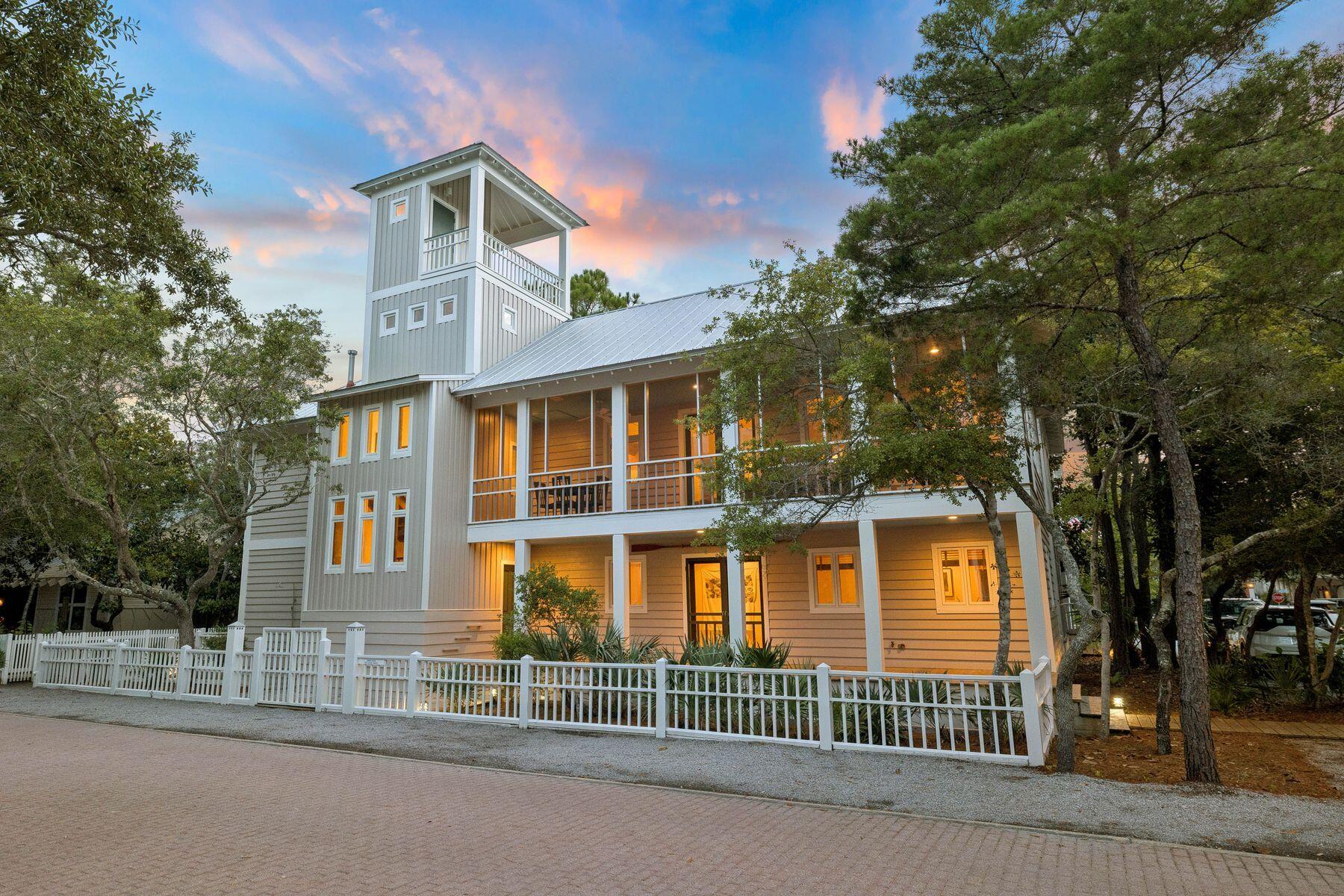 Behind a white picket fence in the heart of Seaside, this 2,416 square foot home offers four bedrooms and four and a half baths, with beautiful porches on the ground level and a sense of privacy that is hard to find in town.

Hardwood floors run throughout the first floor, home to two guest bedrooms and the master suite, each with its own full ensuite bath. The guest bedrooms feature shower tub combos, ceiling fans, and recessed lighting, while the master suite holds a king bed, double vanities, a stand up glass shower enclosure, and windows that fill the room with natural light, with under stairs storage tucked nearby. 

A laundry room finished with cabinets and counter space rounds out the floor. The second floor is where the living space unfolds, anchored by a kitchen outfitted with a gas range and generous counter space alongside a dining area that seats eight, all framed by natural light. A large bedroom on this floor offers built-in bookshelves and cabinetry along with an ensuite bath with a shower tub combo, and a half bath serves the main living area. A screened porch invites true outdoor living, complete with a porch swing for taking in the Seaside evenings.
A third floor loft overlooks the living space below, offering ample sleeping space, and one final rise leads to a fourth floor balcony wrapping two sides of the house for 180 degree views over the treetops of Seaside.
The home sits just a few blocks from the Pensacola Street beach pavilion, with easy access to Seaside's town center, shops, and restaurants.
