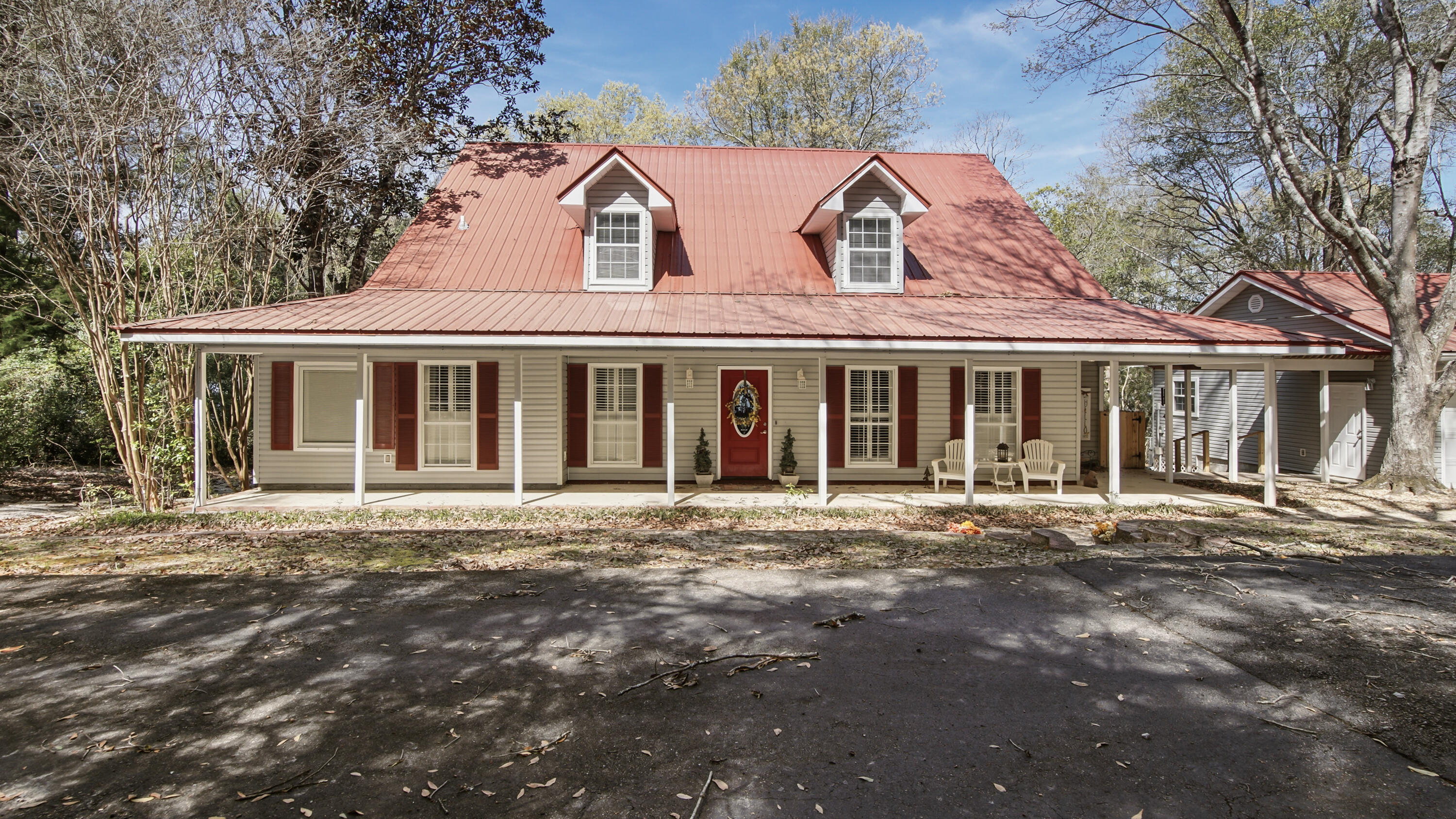 Nestled on 1.3 acres with almost 200 feet of  lake frontage, this impeccably maintained 4 BR 2.5 BA home on Spring Lake is not a listing you find everyday. Stepping into the home, you are greeted with incredible lake views from the open concept living area and kitchen, as well as exceptional views from the main floor master bedroom. The Master Bedroom features a large bath with walk in shower and separate jetted tub  Also located on the main floor is a walk in pantry/laundry room, a formal dining room, a half bath and a screened in sun room for enjoying gorgeous sunset views! 
Upstairs you will find 3 additional bedrooms and a full bath.  

SEE MORE This home has so many extra features such as a certified storm shelter in the master bedroom, a Generac whole home generator, an on demand tankless water heater, RV hookup, an oversized two car garage with attic connected to the home by a breezeway, a whole home security system and the neighborhood even has a FLOCK camera with 24/7 monitoring!
For reduced insurance and peace of mind, the metal roof is less than 3 years old. The septic system was replaced in 2025. 
Travel from the back deck down the very gently sloped yard to the showstopper of this property, gorgeous Spring Lake! Spring Lake Estates is a small community of homeowners who enjoy a quiet, peaceful way of life in the lakeside community built around a 150-acre private lake. Amenities include a large dock & boat launch area, pole barn & community gathering space, smaller common area dock for relaxation and two dedicated community access points. 
There is a mortgage on the home of approximately $300,000 that may be assumable at 2.25% interest rate.