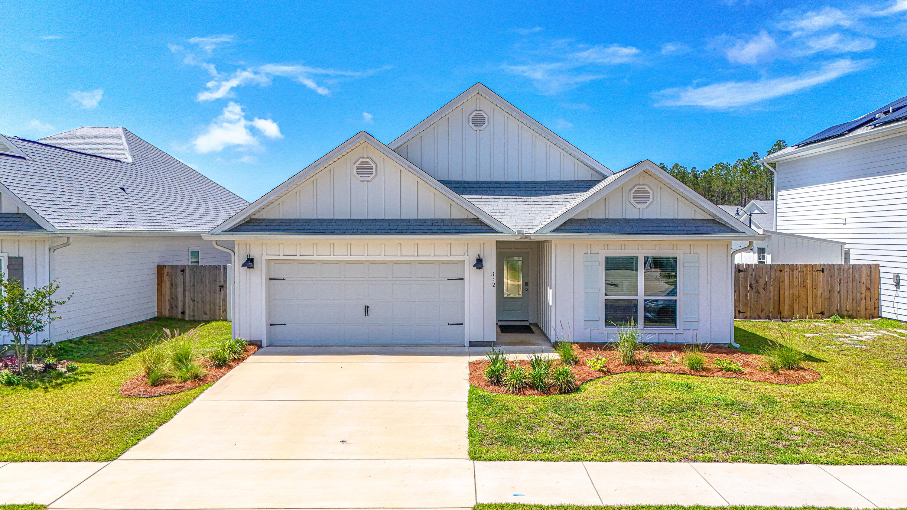 Move In Ready 'DELRAY'Model. Welcome to 142 Butler Cove in the Bayside at Ward Creek community, a darling coastal home featuring one of the community's most loved and functional floor plans. This single-story Delray plan offers 4 bedrooms, 2 bathrooms, 9-foot ceilings, and durable LVP flooring throughout with no carpet anywhere in the home. The open-concept layout was designed with easy living and entertaining in mind, with the living, dining, and kitchen spaces flowing seamlessly together. The kitchen is full of thoughtful upgrades including granite countertops, a farmhouse sink, stainless steel appliances, and a large island perfect for gathering & entertaining! Right off the living area, you'll find a spacious screened porch overlooking the fenced backyard, creating the perfect spot to relax after a day at the beach! 
Tucked away at the back of the home, the oversized primary suite offers  two closets and a beautifully updated en-suite bathroom featuring a modern tiled shower. The split-bedroom layout places three additional bedrooms toward the front of the home, making them ideal for guests, a home office, hobby space, or growing families. The 2-car garage even includes an electric vehicle charging system for added convenience.
Bayside at Ward Creek is a growing community with amenities the whole family can enjoy, including a community pool and playground. Located just minutes from Pier Park, the crystal white sand beaches of PCB & Frank Brown Park, Pirate's Voyage, and some of the area's best boating and fishing spots, this location truly offers the best of coastal living! Come see it today!