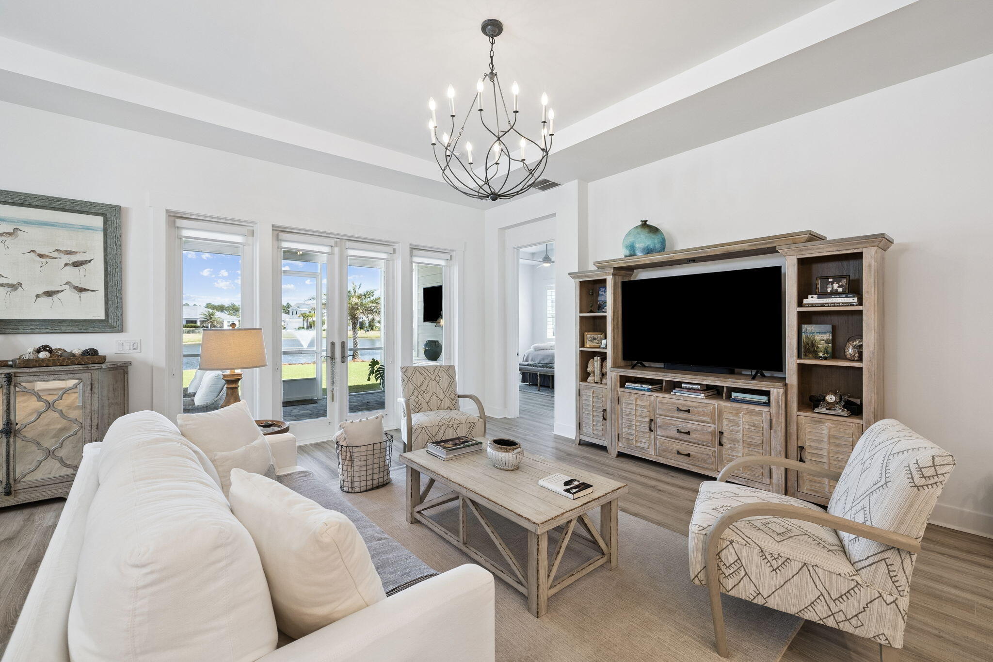 A single level, spacious floorplan on a pool size lot with 50 ft of waterfront, offering views from the Living Room, Dining Room, Primary Suite and Screened-In Lanai.  This modern design has 1952 sq. ft. of living space including two bedrooms; a private flex room being used as office space but easily converted to a full-time 3rd bedroom if needed, and two full bathrooms.  The property, located in the first phase of Naturewalk is the only gated community within Watersound Origins. Naturewalk has a private amenity center, available only to their homeowners.  Enjoy resort s style pool with cabanas, spa, firepit, gathering areas and a well-equipped fitness center, pickle ball and tennis courts.  AND, as a homeowner you can play golf on the 10-hole course.  Shopping and Dining is made easy with the newly developed Town Center that is walkable or by a short 5-minute drive.  To learn about Town Center go to www.watersoundtowncenter.com.  No short-term rentals are allowed and only 10 minutes from the famous 30A Highway where you can enjoy the Gulf beaches along with popluar Rosemary Beach and Alys Beach.  If you are seeking a resort lifestyle community - consider Naturewalk at Watersound Origins.  I invite you to tour 122 Pennekamp Lane.  A Move-In Ready Home that may be just what you are looking for.