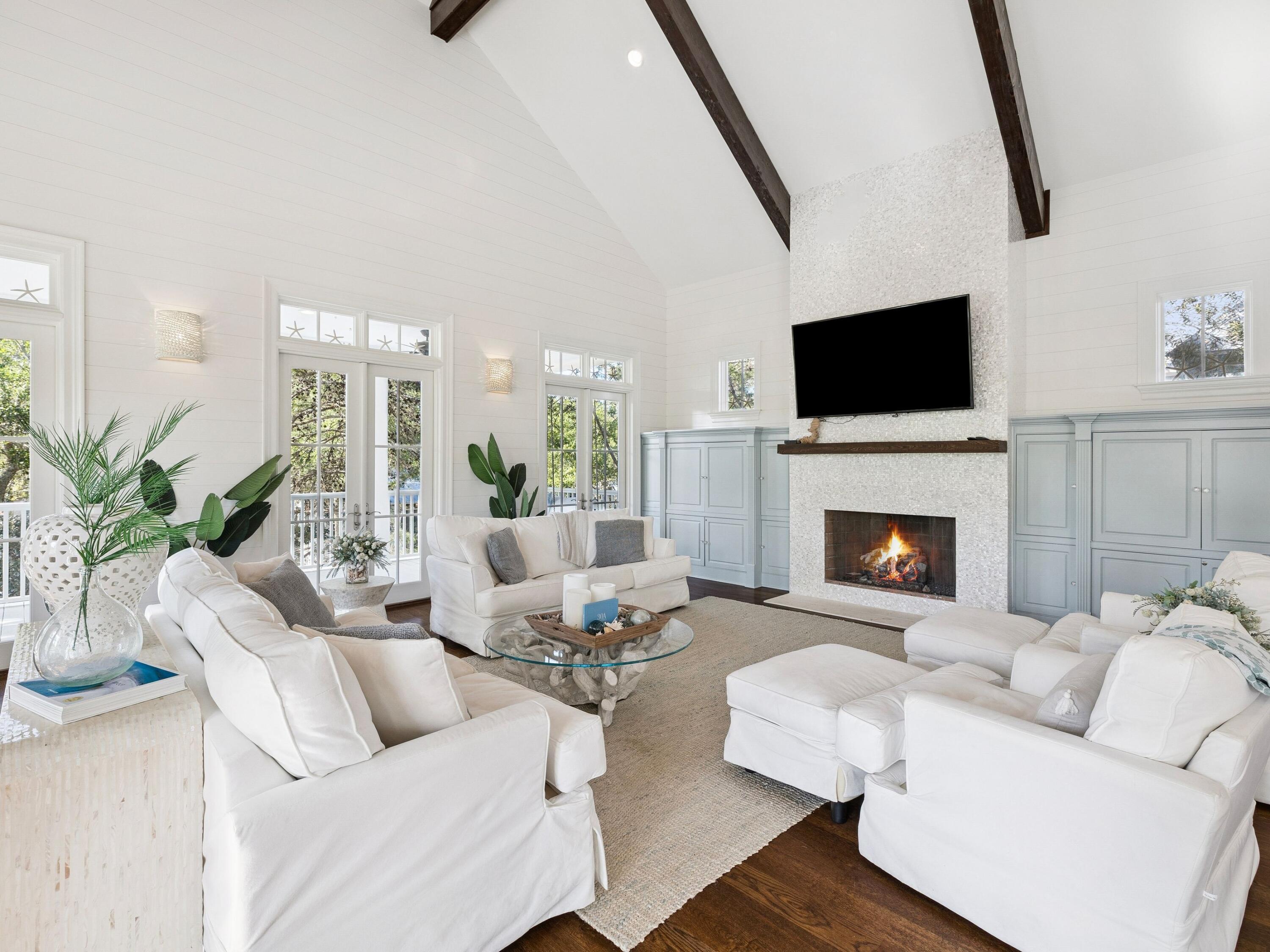 Experience refined coastal luxury in this exceptional five bedroom, four full and one half bath residence spanning 3,774 square feet, ideally positioned on one of the most sought after lots in WaterColor's highly desirable Phase 3 within the coveted Lake District. Set on a premier corner lot, the property offers privacy on three sides, creating a setting that feels far more secluded than most.

Just moments from Western Lake and a short bike ride to the beach, this beautifully appointed home offers the perfect blend of elegance, comfort, and true resort style living. The wrap around porch is a standout feature, giving you multiple spaces to relax, entertain, and take in the surroundings throughout the day. Designed for both relaxation and entertaining, the home features a private pool, complemented by a newly enhanced pergola and thoughtfully designed outdoor living spaces, ideal for al fresco dining and lounging in a serene setting.

Inside, the home showcases timeless coastal design and quality craftsmanship throughout. The gourmet chef's kitchen is outfitted with a six burner gas range, custom vent hood, premium appliances, wine refrigerator, warming drawer, and an expansive island with bar seating. The main living area is highlighted by soaring vaulted ceilings, exposed beams, a statement fireplace, and elegant shiplap detailing, creating a warm yet elevated atmosphere.

Recent updates, including fresh interior and exterior paint and upgraded outdoor features, enhance the home's pristine condition and modern appeal. A spacious third floor game room with custom built bunks offers a versatile retreat for guests and gatherings.

Owners enjoy access to WaterColor's world class amenities, including multiple resort style pools, tennis and pickleball courts, a state of the art fitness center, scenic parks, and a boathouse for paddleboarding and kayaking. Camp WaterColor adds to the experience with its lazy river, waterslides, and family friendly activities. The property conveys 14 owner wristbands, a meaningful advantage for both personal use and rental flexibility.

This is a rare opportunity to own a truly distinguished home in one of 30A's most sought after coastal communities.
