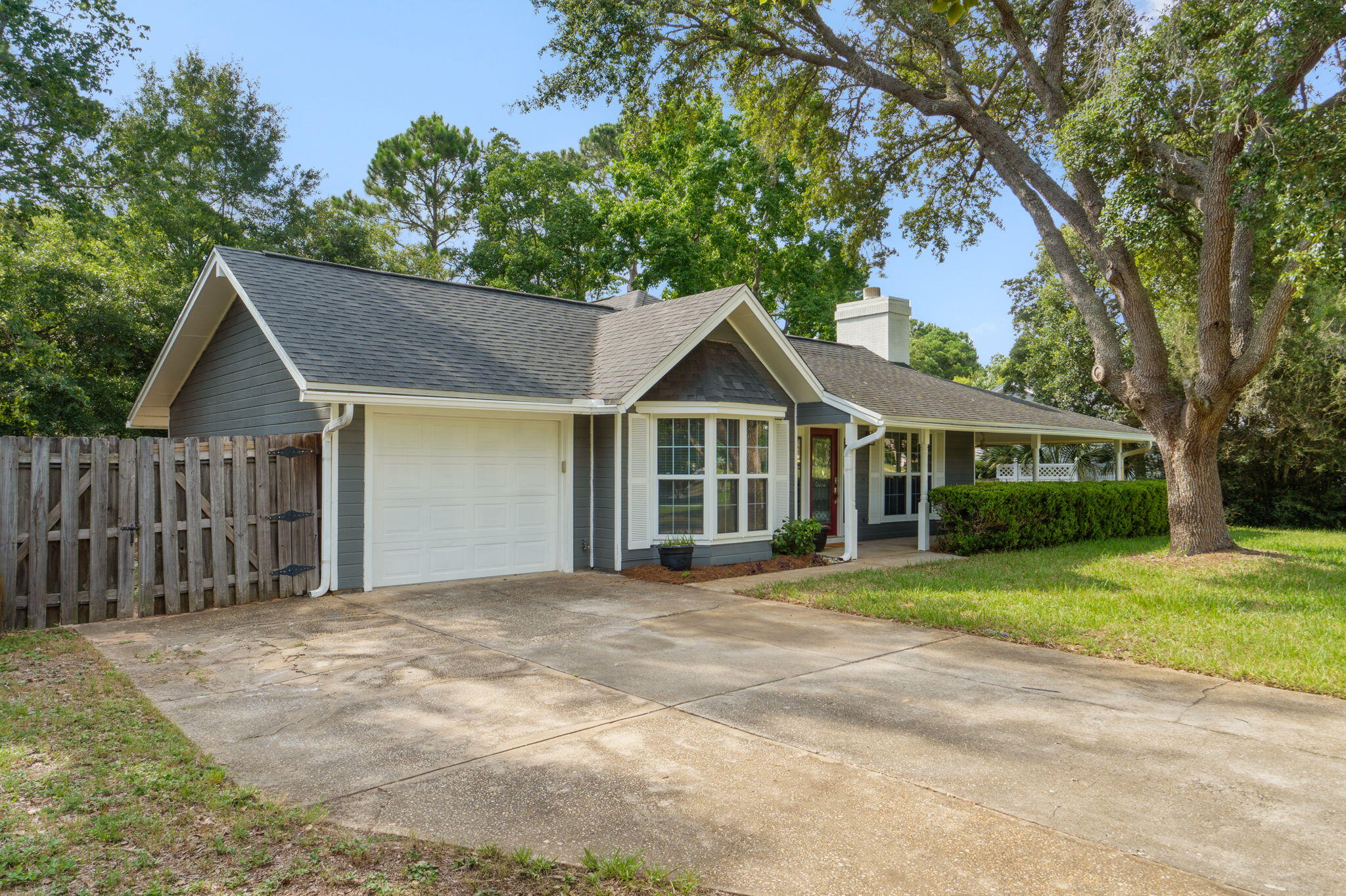 Welcome home to a perfect blend of rustic elegance, modern updates, and that old Florida character. Situated on a quiet street framed by mature trees, this stunning 3 bedroom residence offers the ultimate Florida lifestyle; with the rare peace of mind that comes from having all three major systems fully updated (Roof 2020, brand-new HVAC 2026, and a brand-new water heater 2026).

The standout feature of the exterior is the expansive, wrap-around front porch. Covering over 50% of the home's exterior, this fully covered outdoor living space comes complete with ceiling fans and lighting, making it the perfect spot to enjoy your morning coffee or unwind in the evening while looking over the freshly landscaped front yard.

Step inside to an oversized living room that serves as the true heart of the home. The space is centered around a gorgeous fireplace and defined by stunning, custom wood-beam architecture on the ceilings that adds incredible warmth and character. The kitchen features sleek stone granite countertops, newer appliances, and plenty of prep space, and flowing natural light from the board picture window dining room. All bedrooms have fresh brand new carpets.

Out back, the massive fully fenced backyard is absolutely perfect for pets to roam safely, hosting weekend barbecues, or adding a pool. The property also features updated landscaping and a dedicated lawn irrigation system to keep your grass vibrant year-round.
